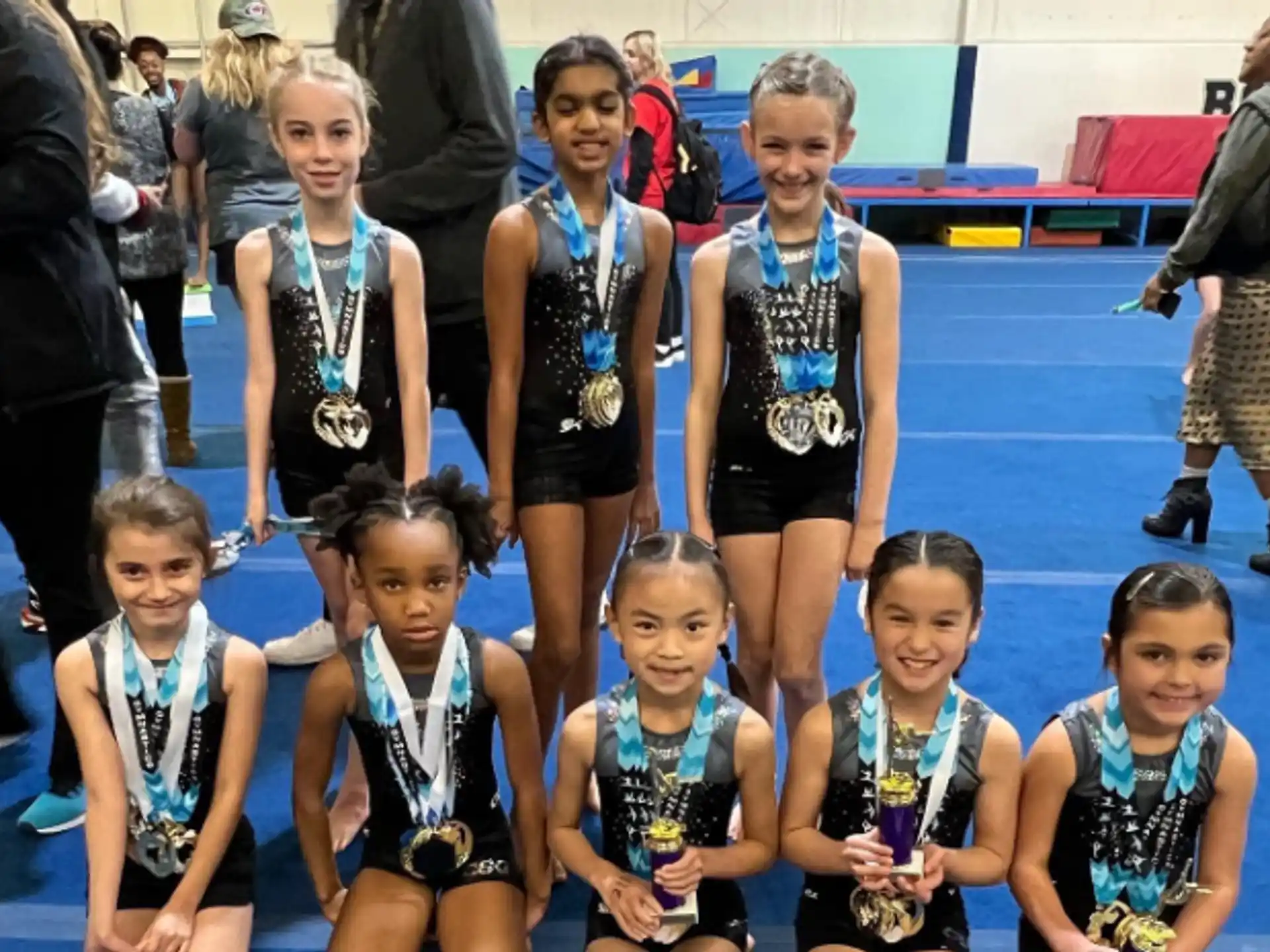 a group of girls wearing medals