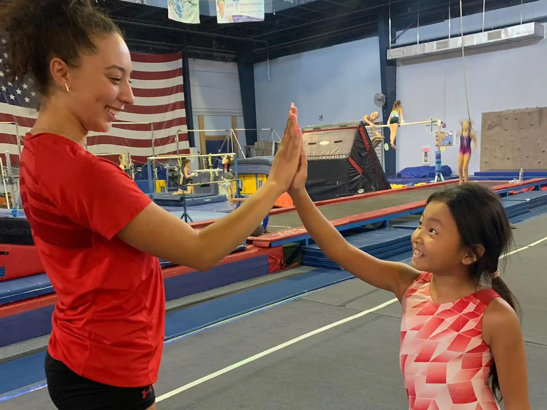 a person and a child in a gym