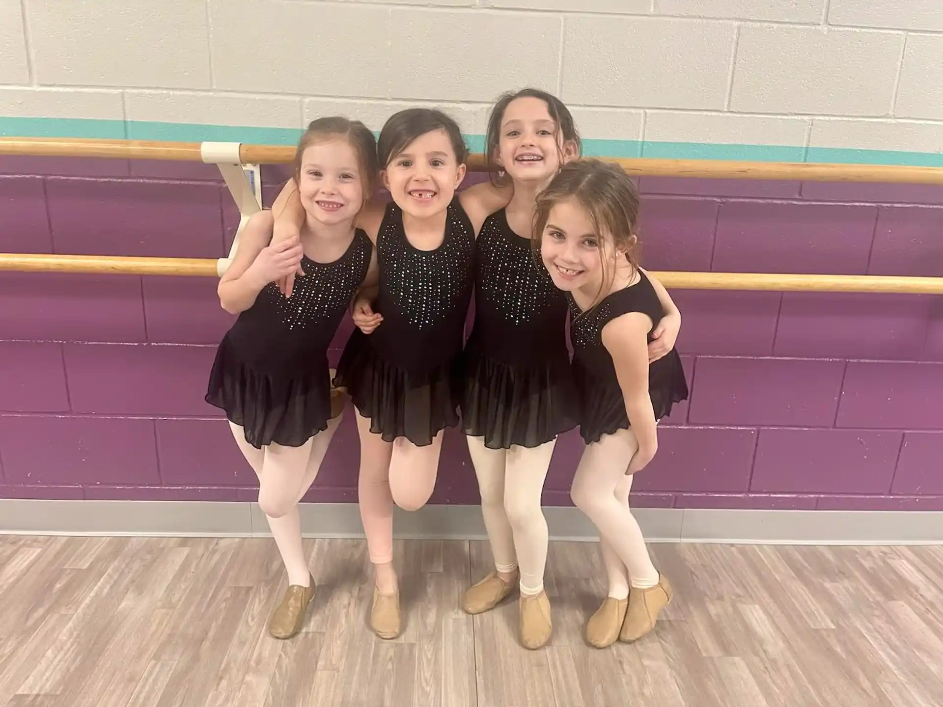 a group of girls in black dresses