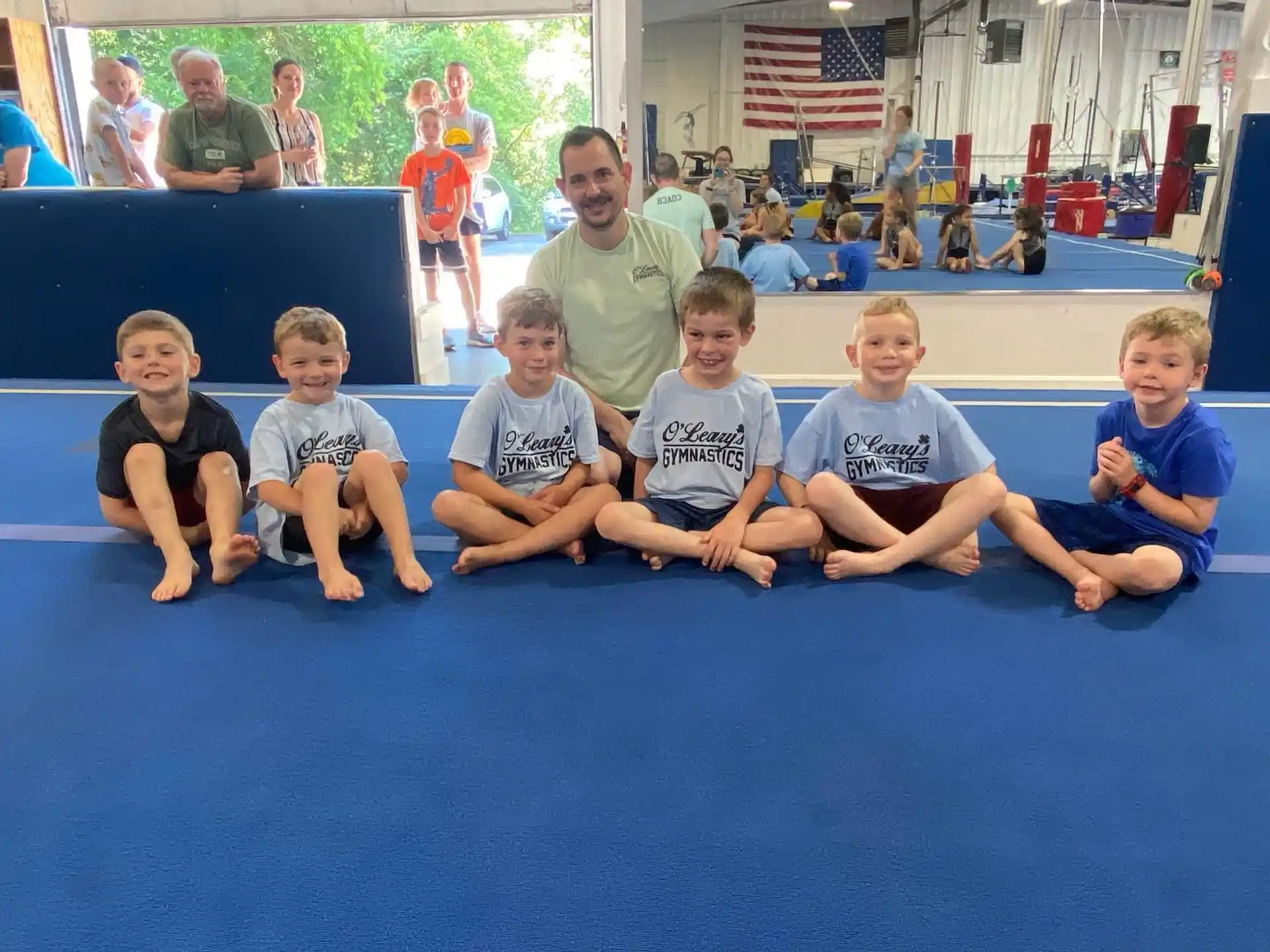 a group of kids sitting on a mat