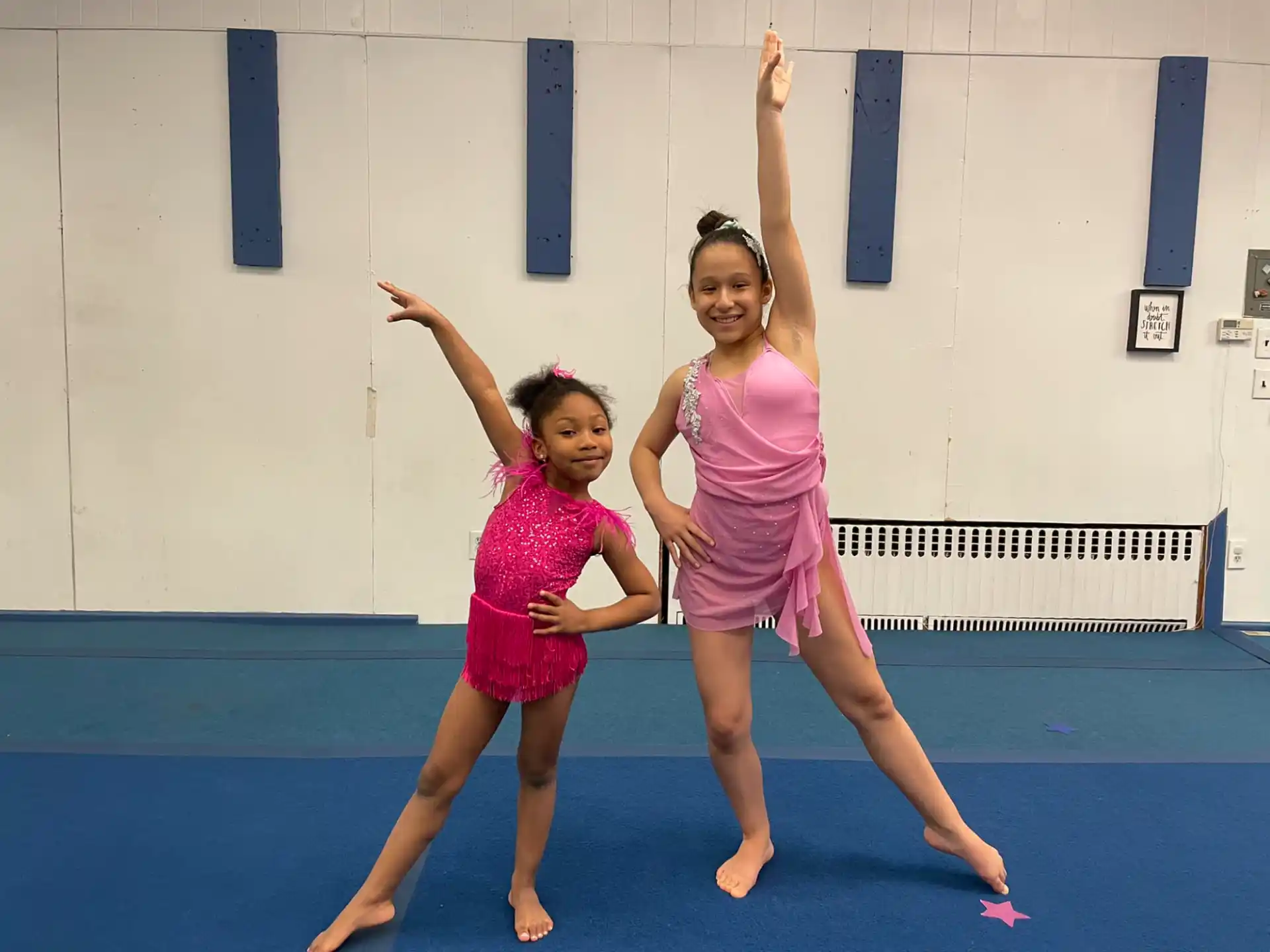 two girls in dresses dancing