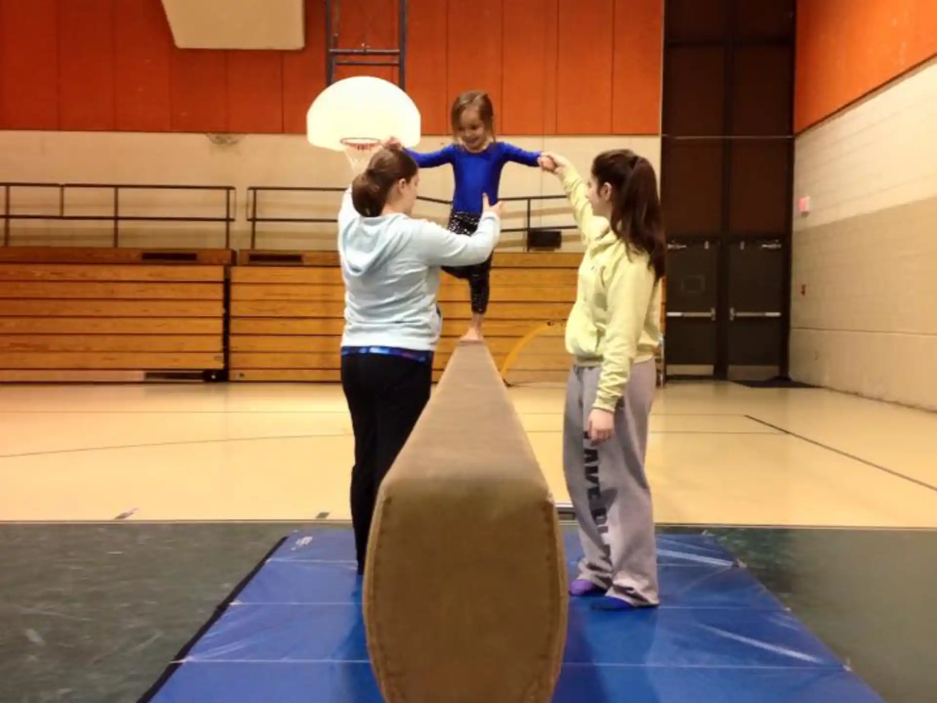 a group of people standing on a large exercise ball