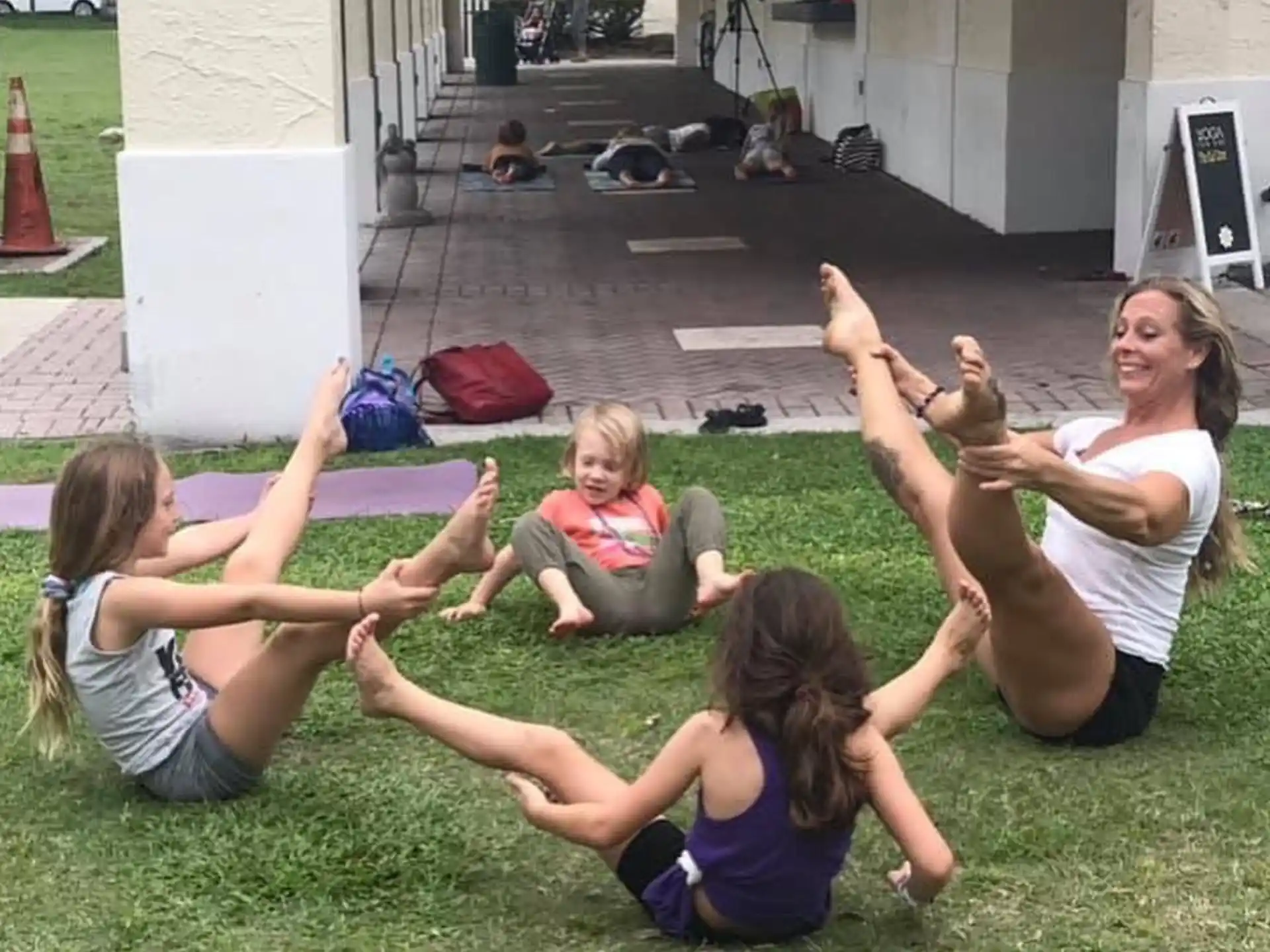 a group of people sitting on the grass