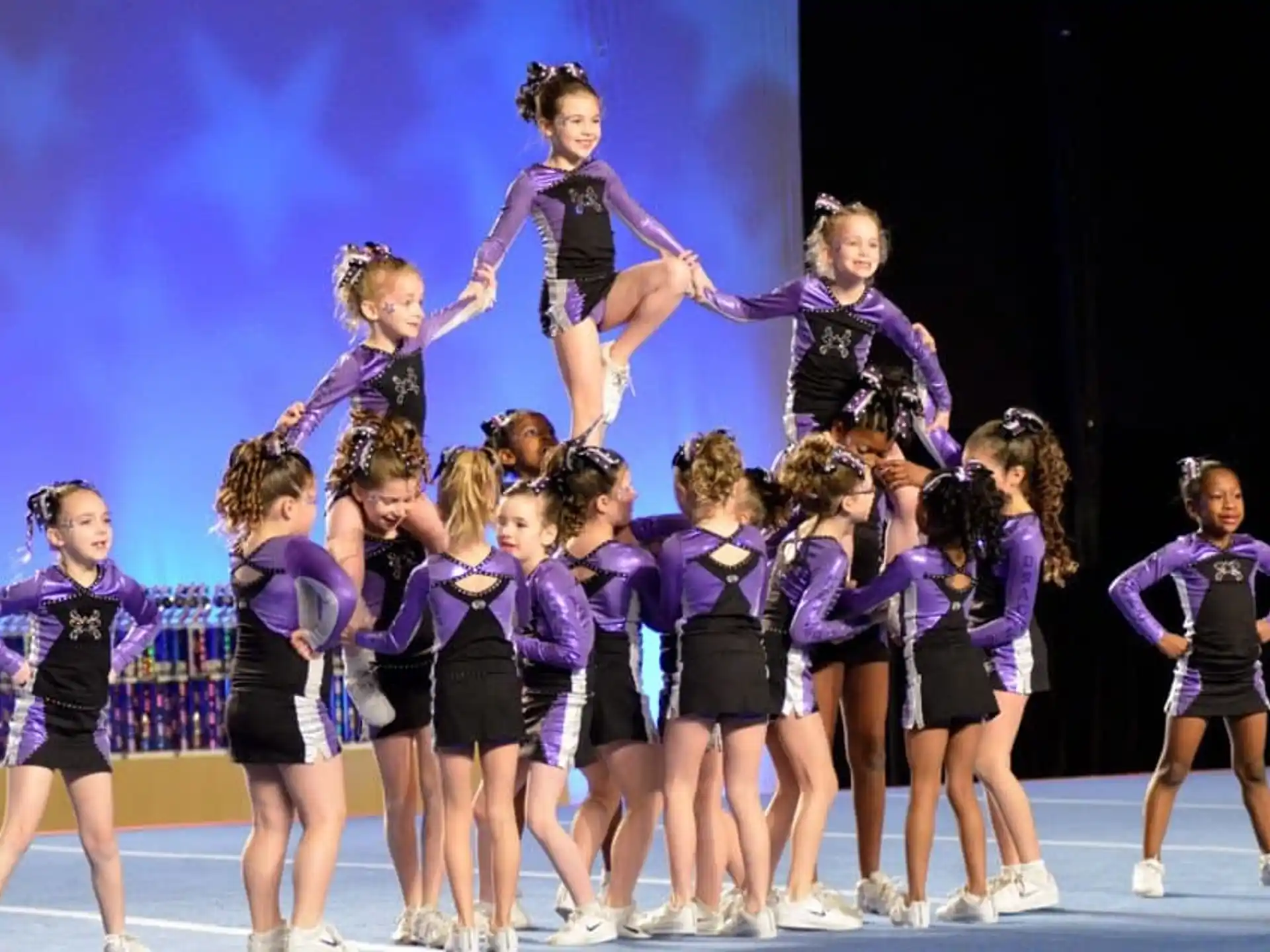 a group of girls in purple uniforms