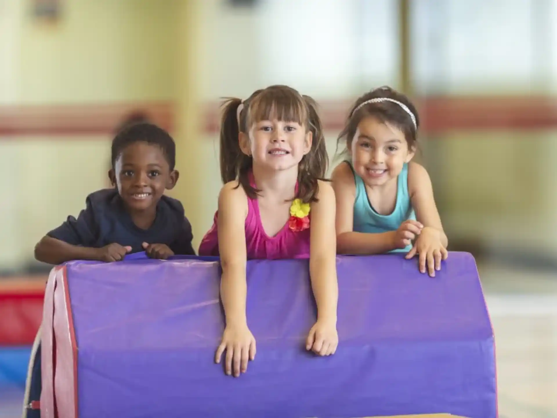 a group of children sitting on a mat