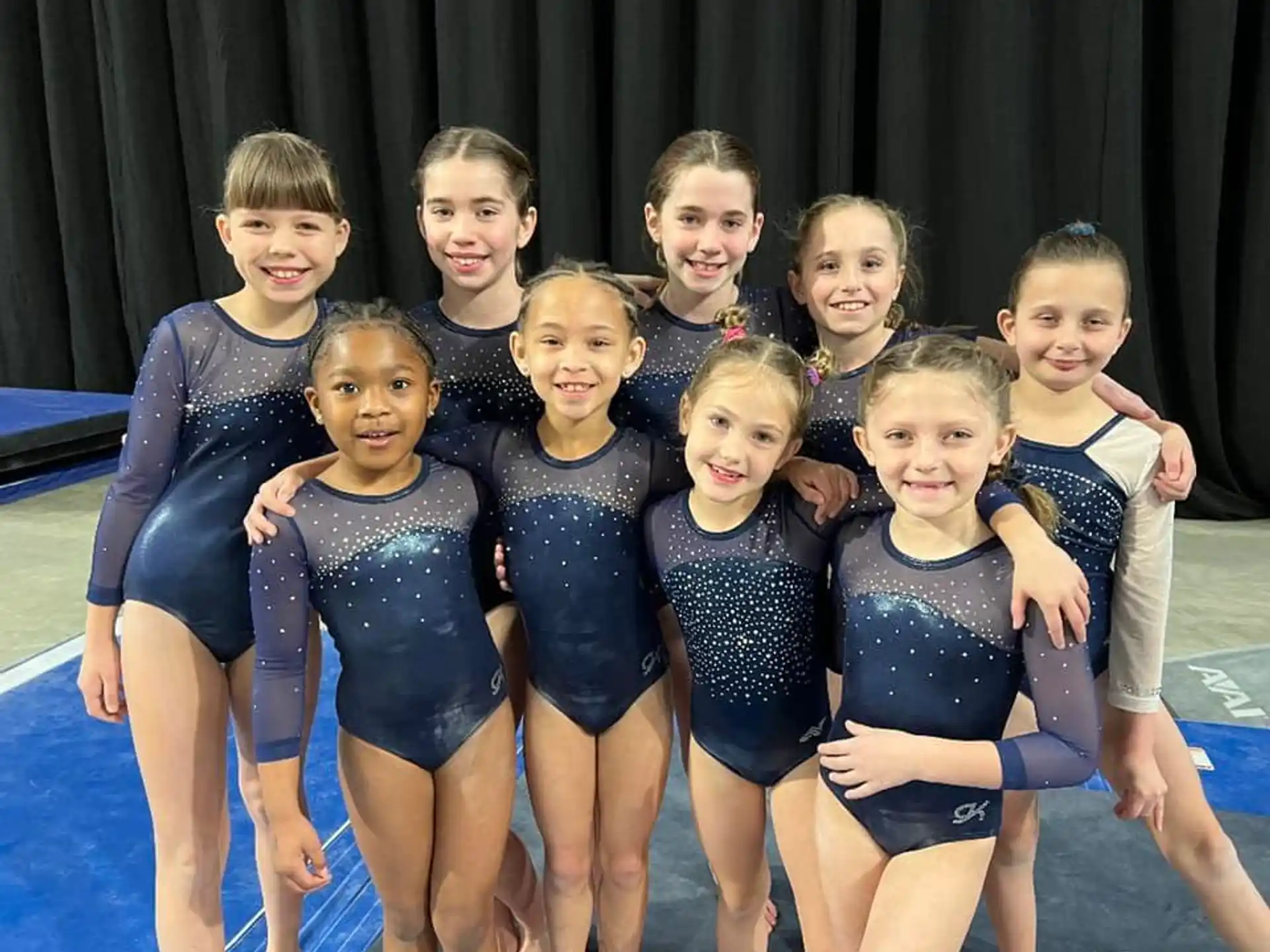a group of girls in swimsuits posing for a photo