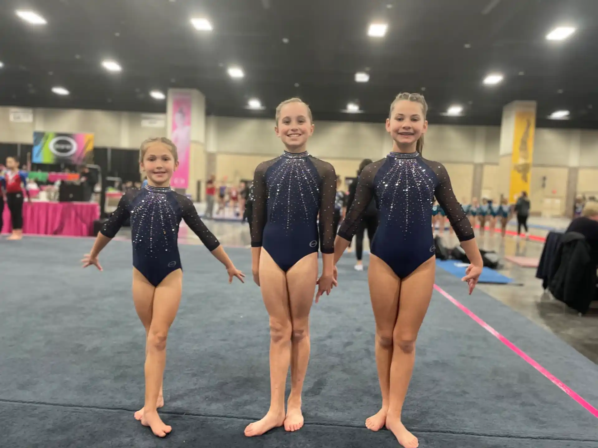 a group of women in leotards posing for a photo