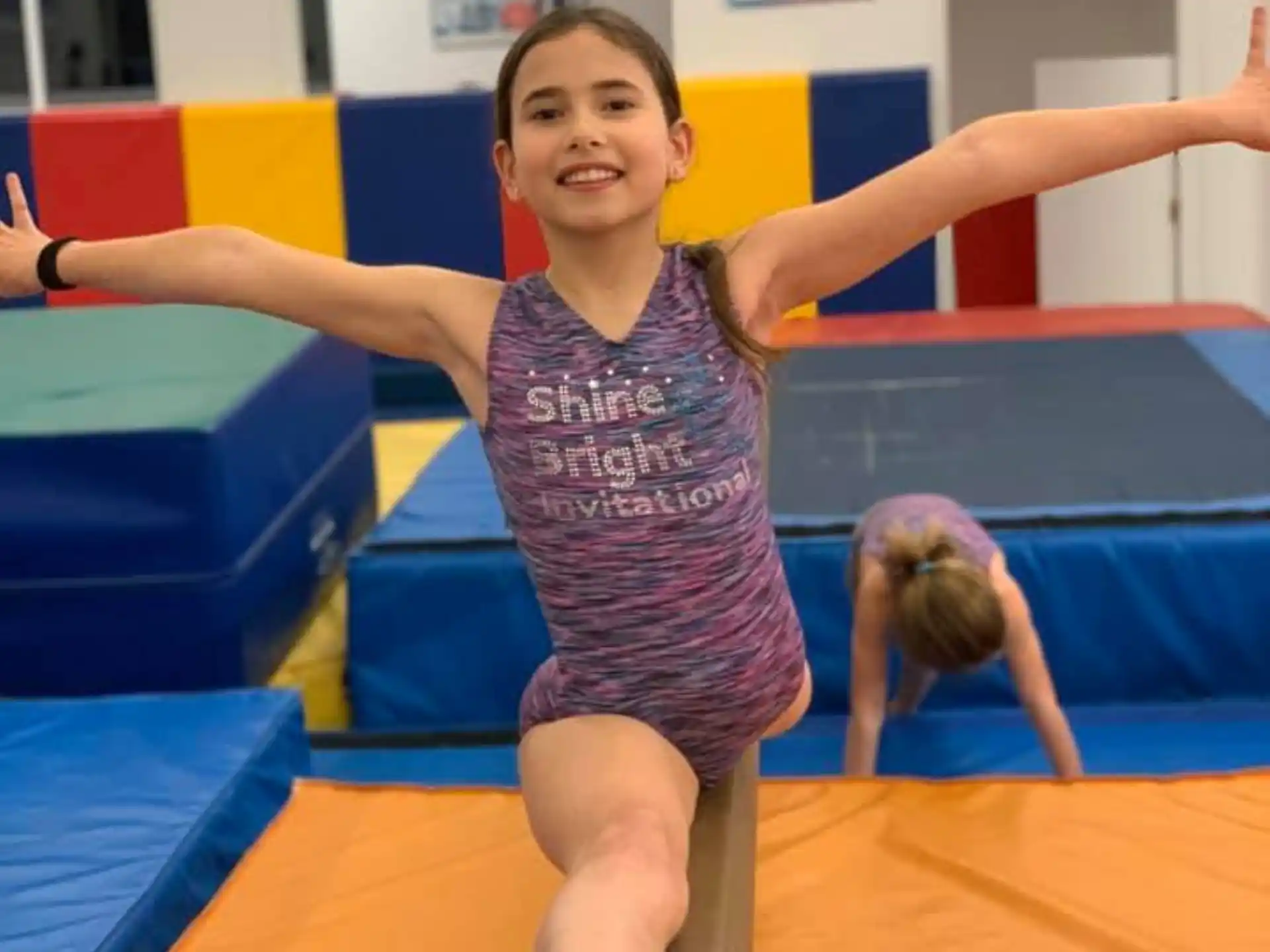 a girl standing on a mat