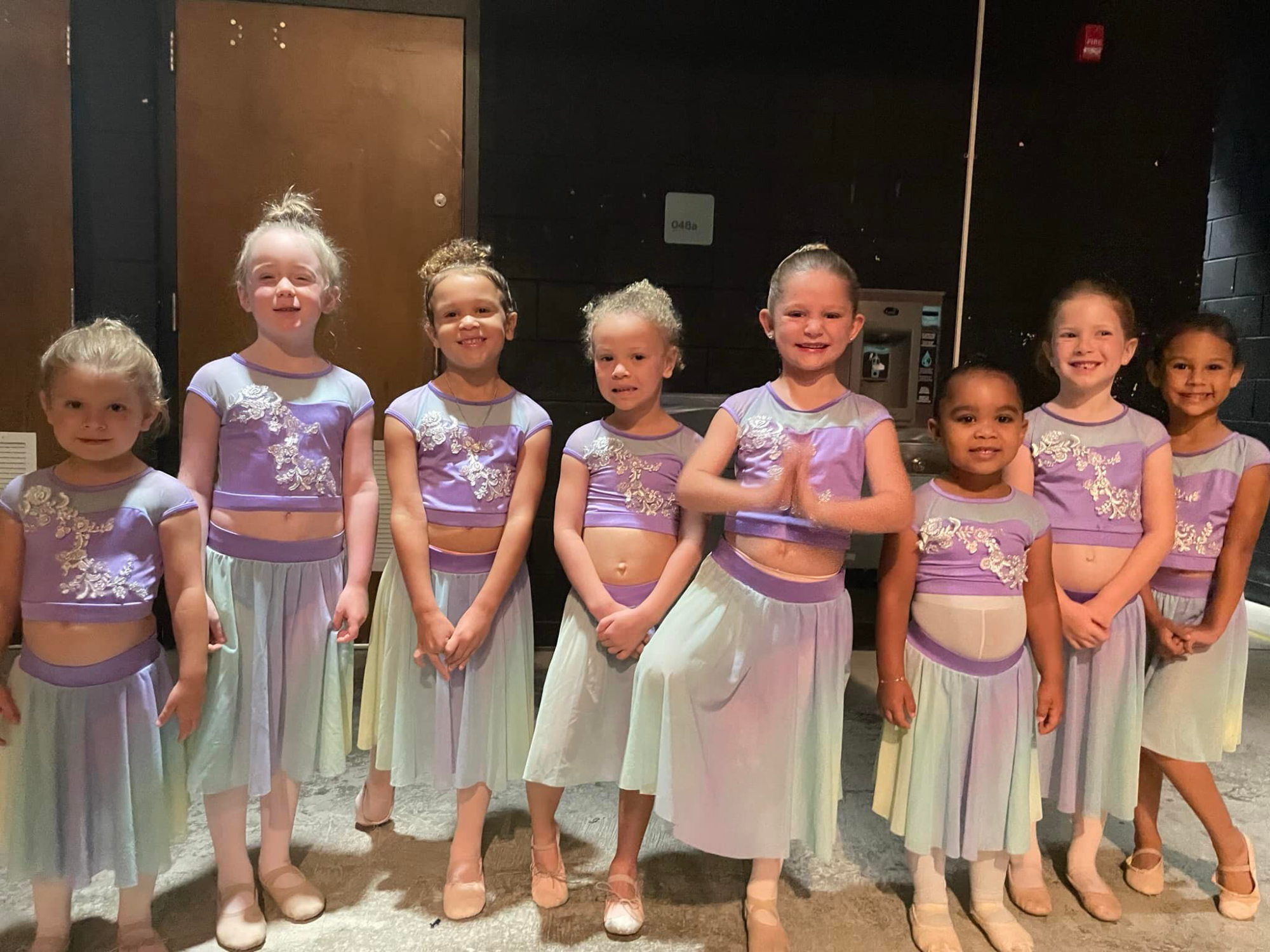 a group of girls in matching outfits
