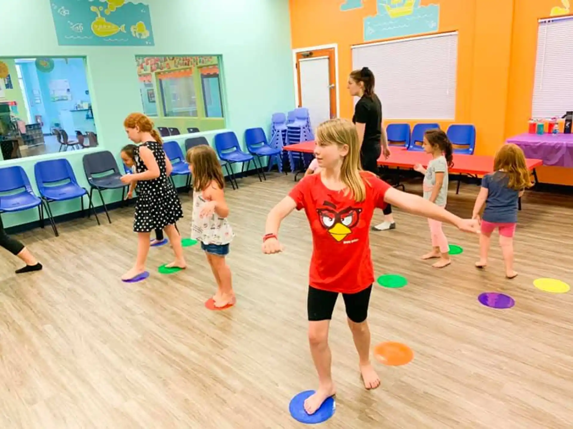 a group of children playing with frisbees