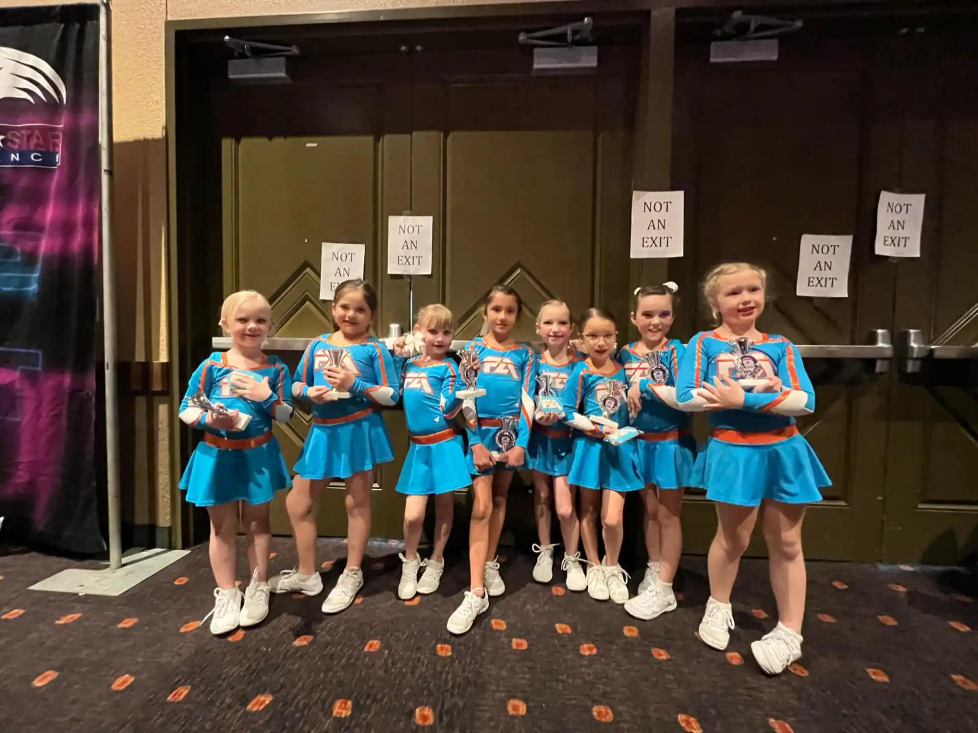 a group of girls in blue dresses