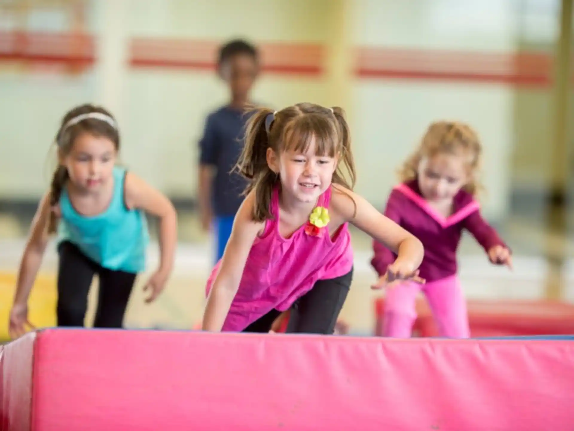 a group of children playing on a trampoline