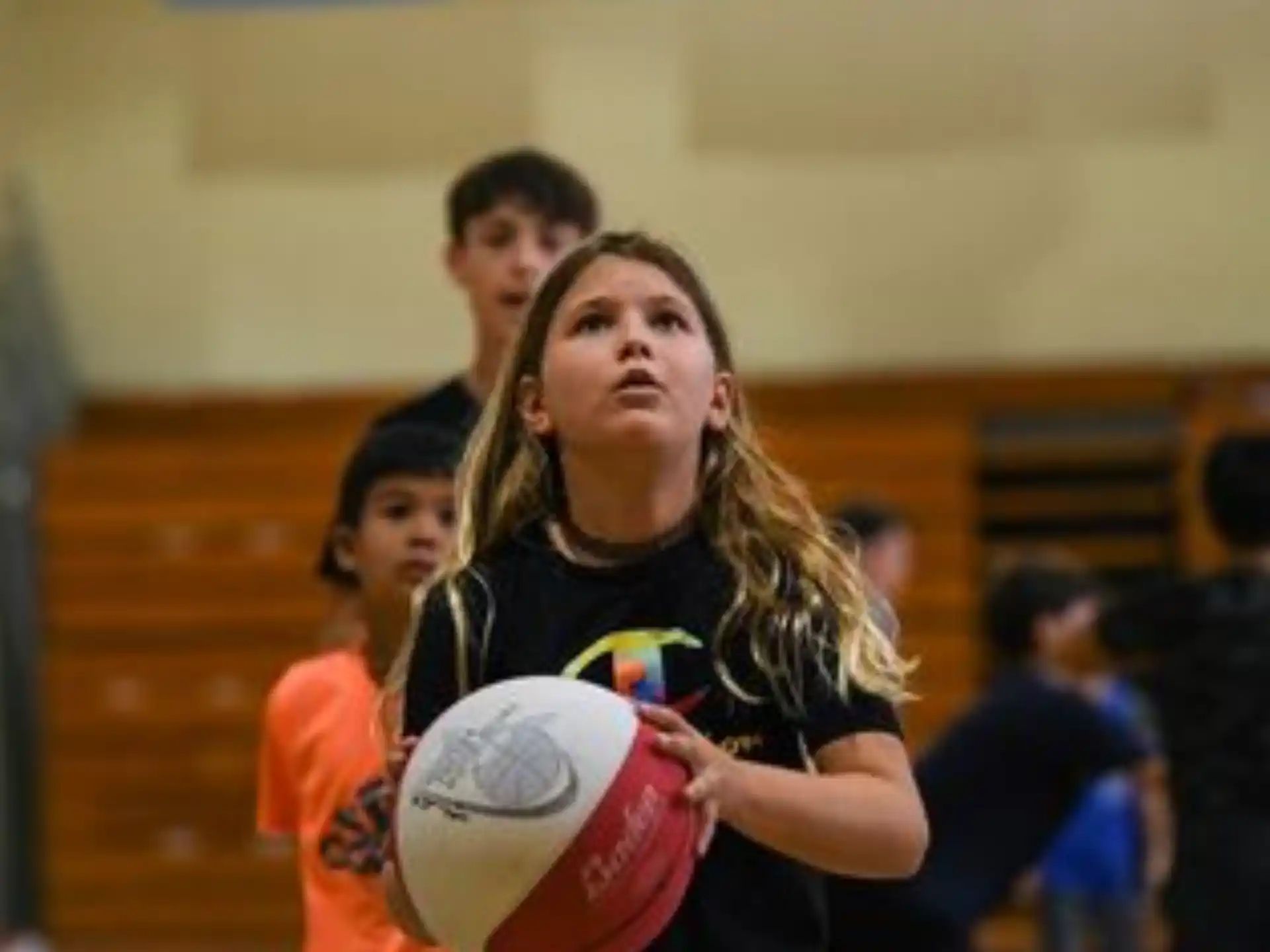 a girl holding a ball