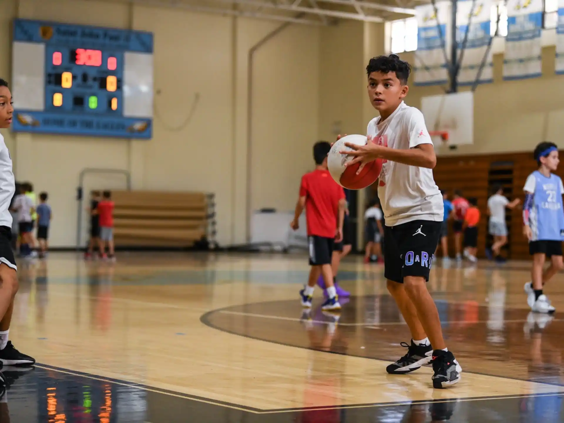 a group of kids playing basketball