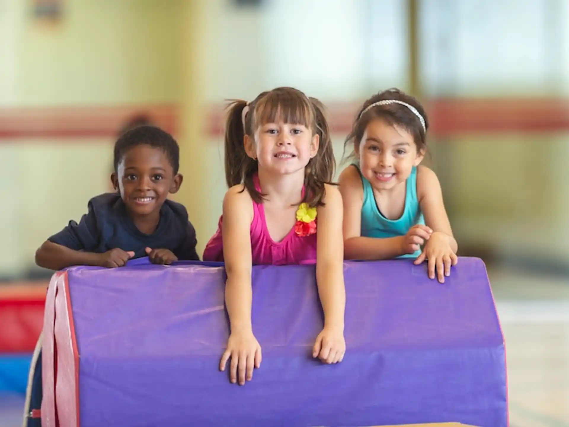 a group of children sitting on a mat