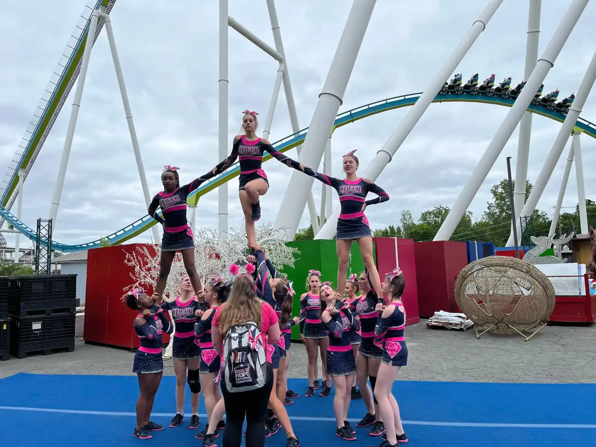 a group of cheerleaders on a blue and white track