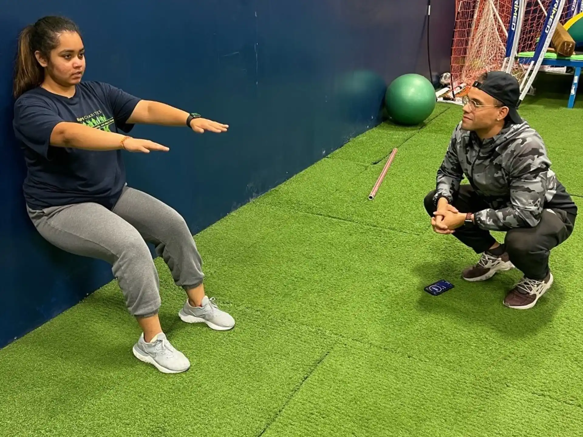 a woman and a man playing a game on a green indoor