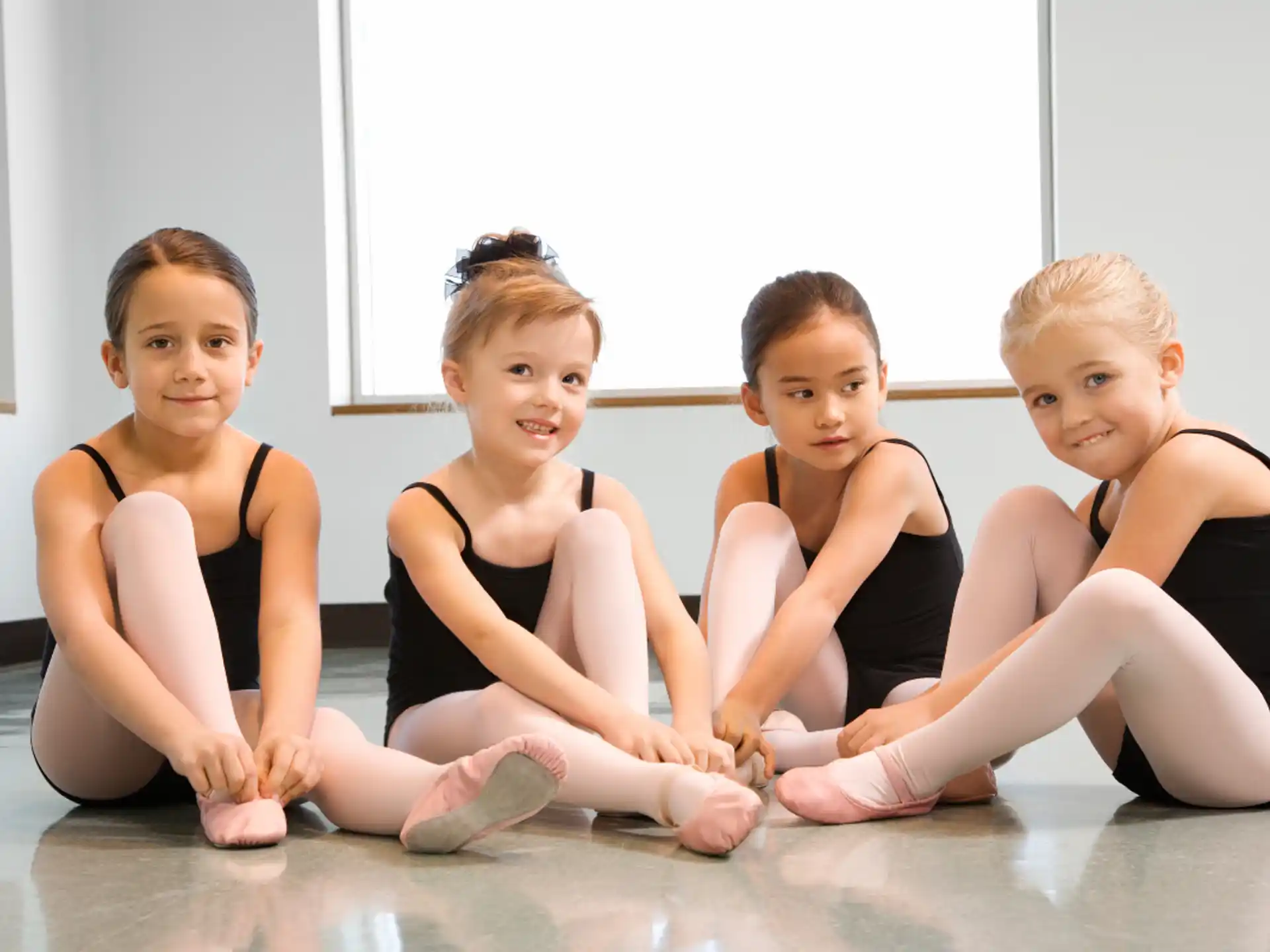 a group of girls sitting on the floor