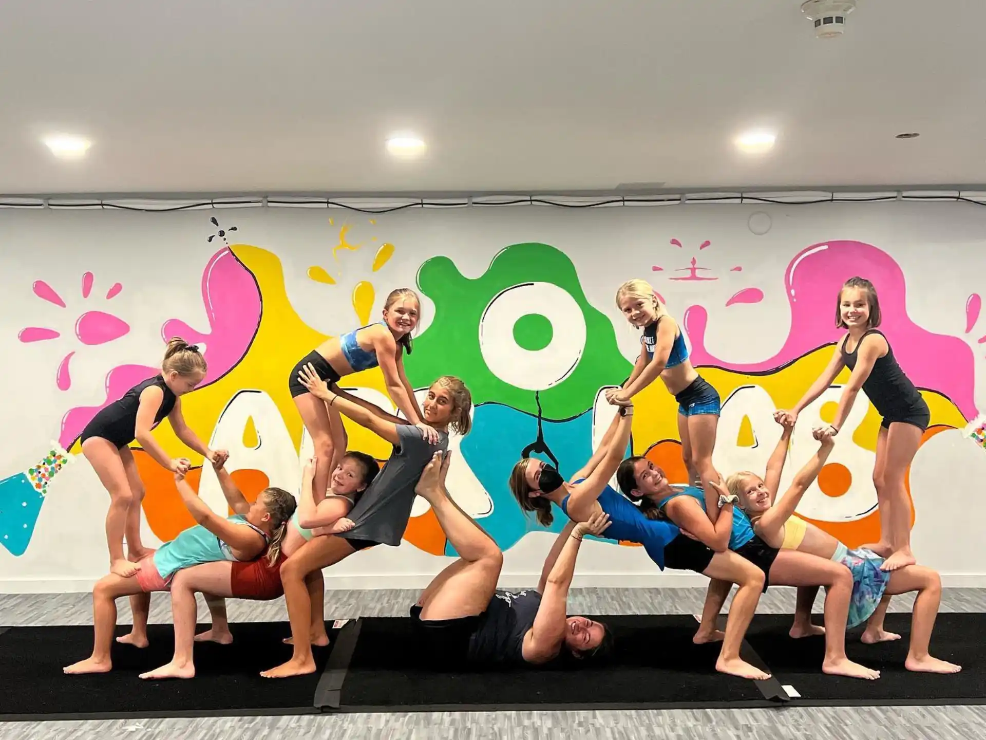 a group of people posing for a photo in front of a wall