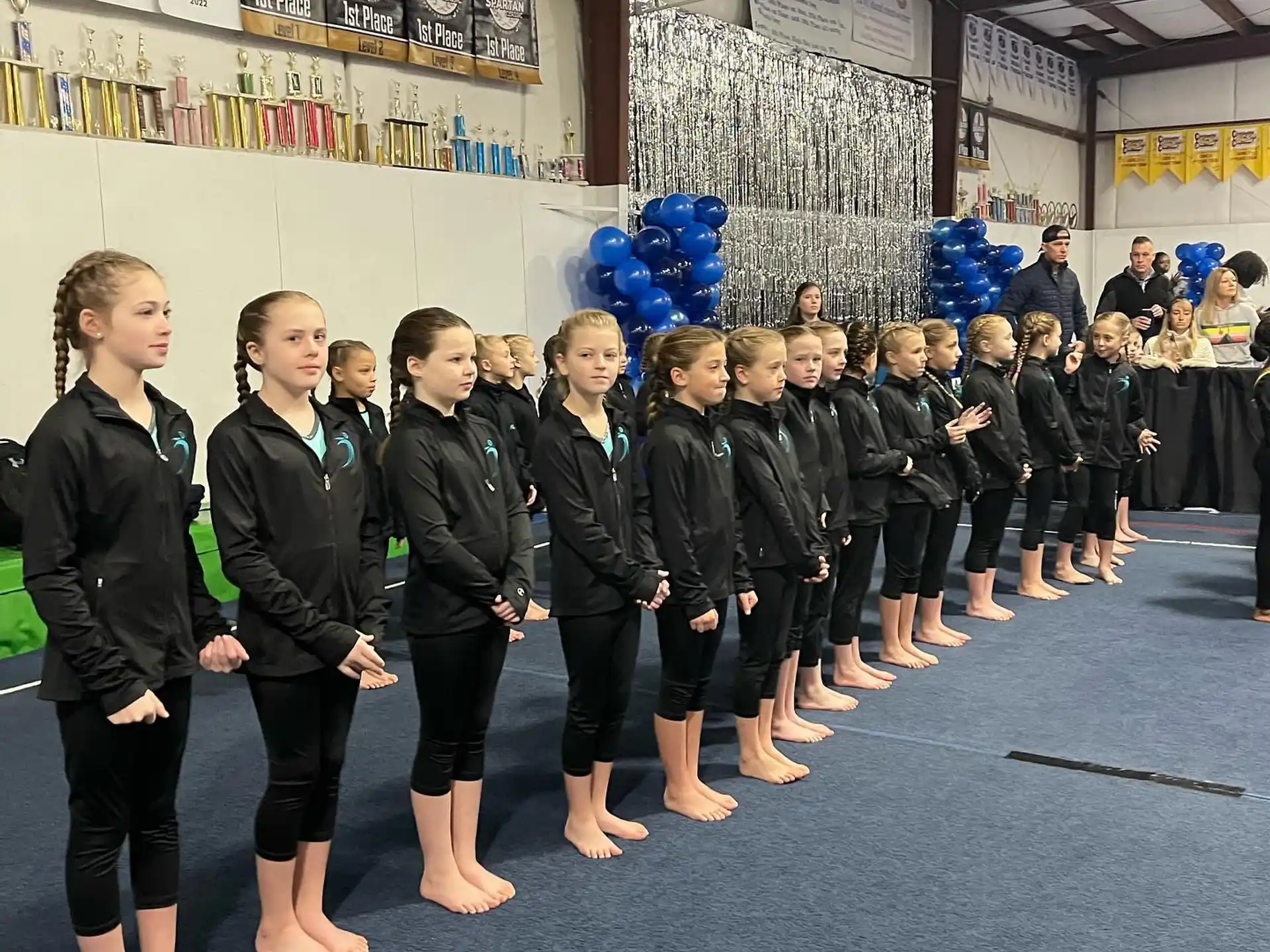 a group of girls in black karate uniforms