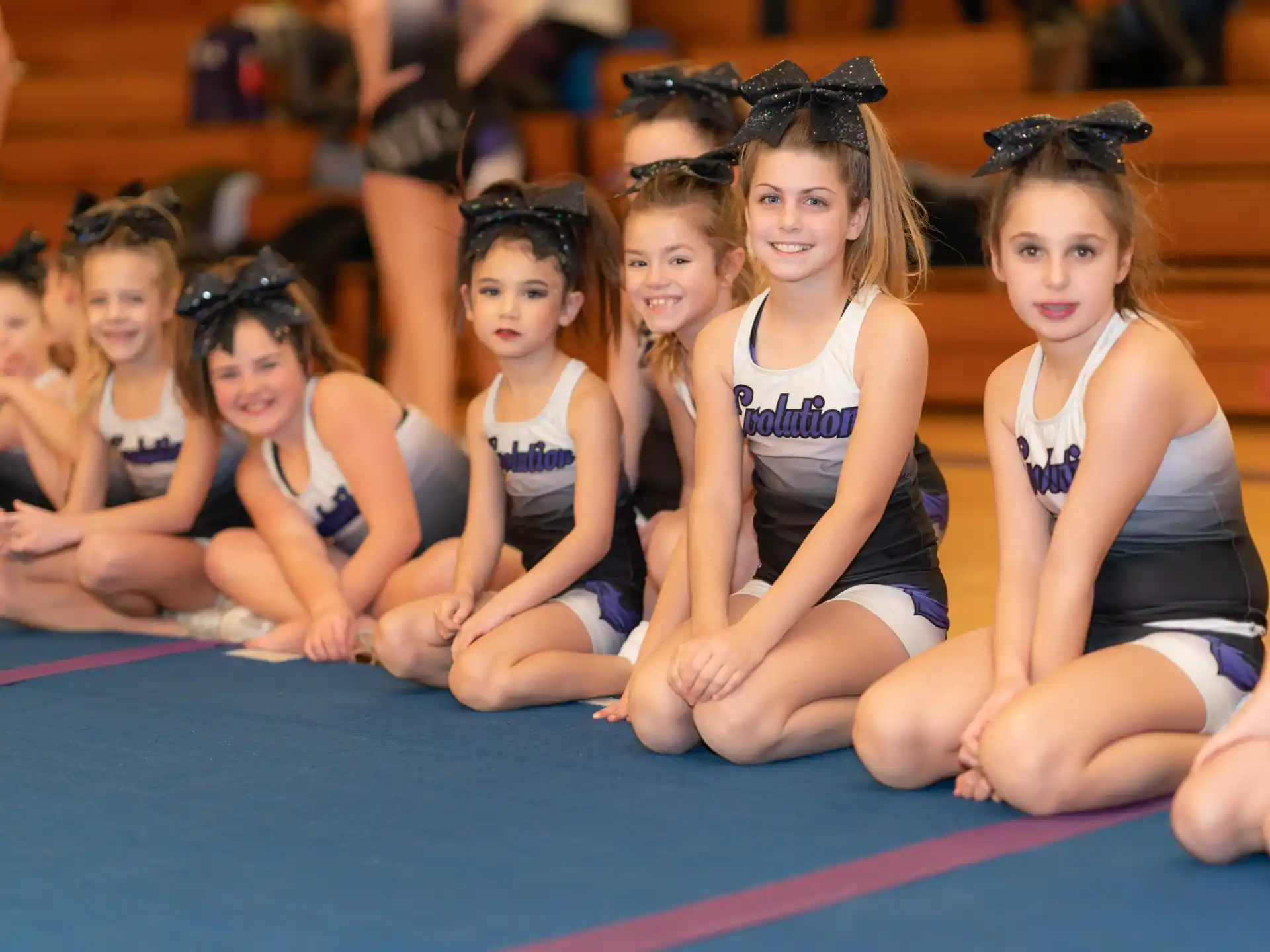 a group of girls sitting on the floor
