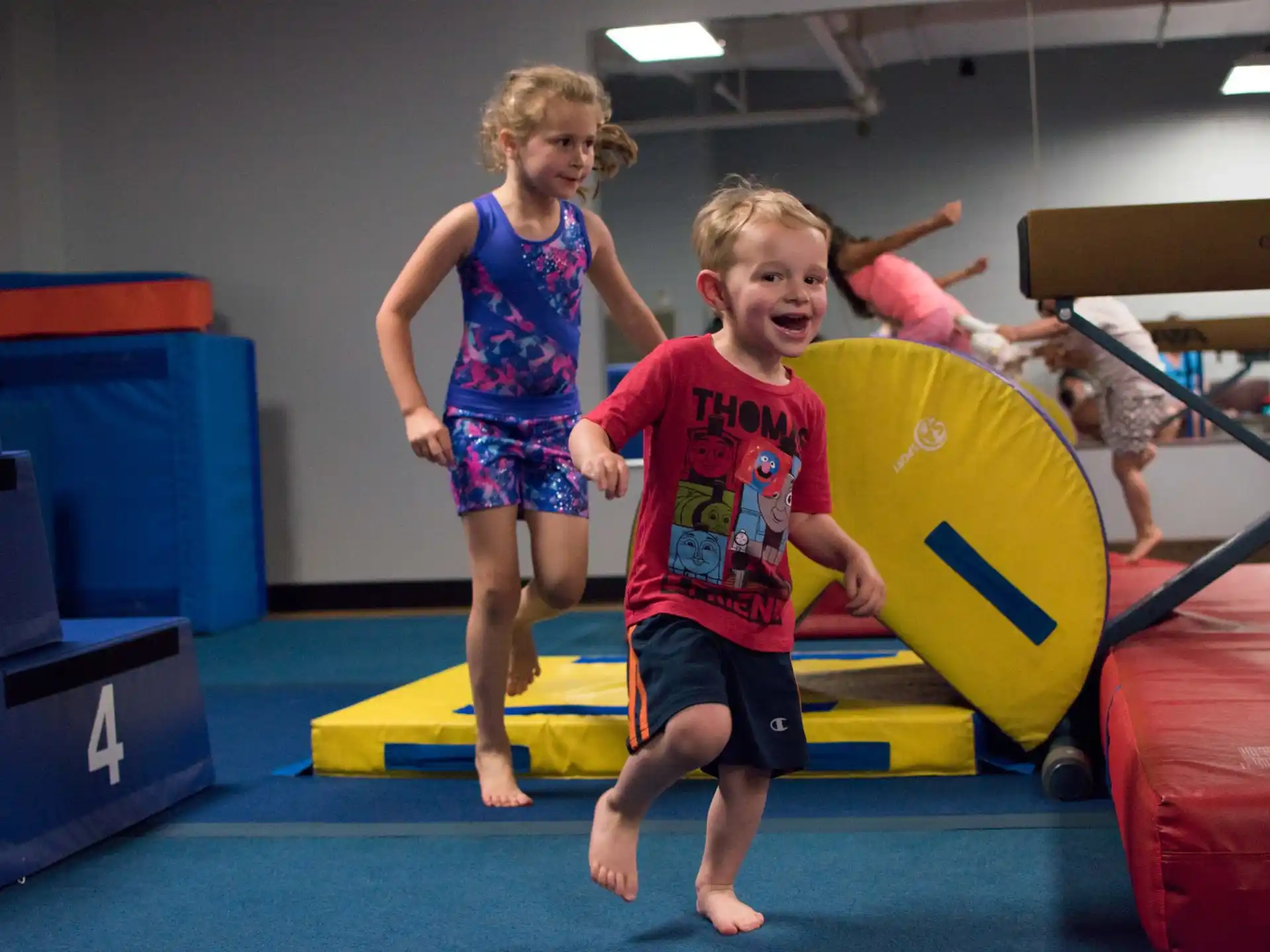 a couple of children playing on a trampoline