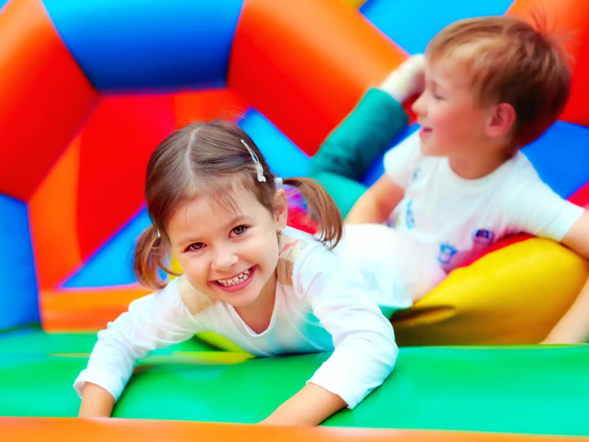 a couple of children playing on a playground