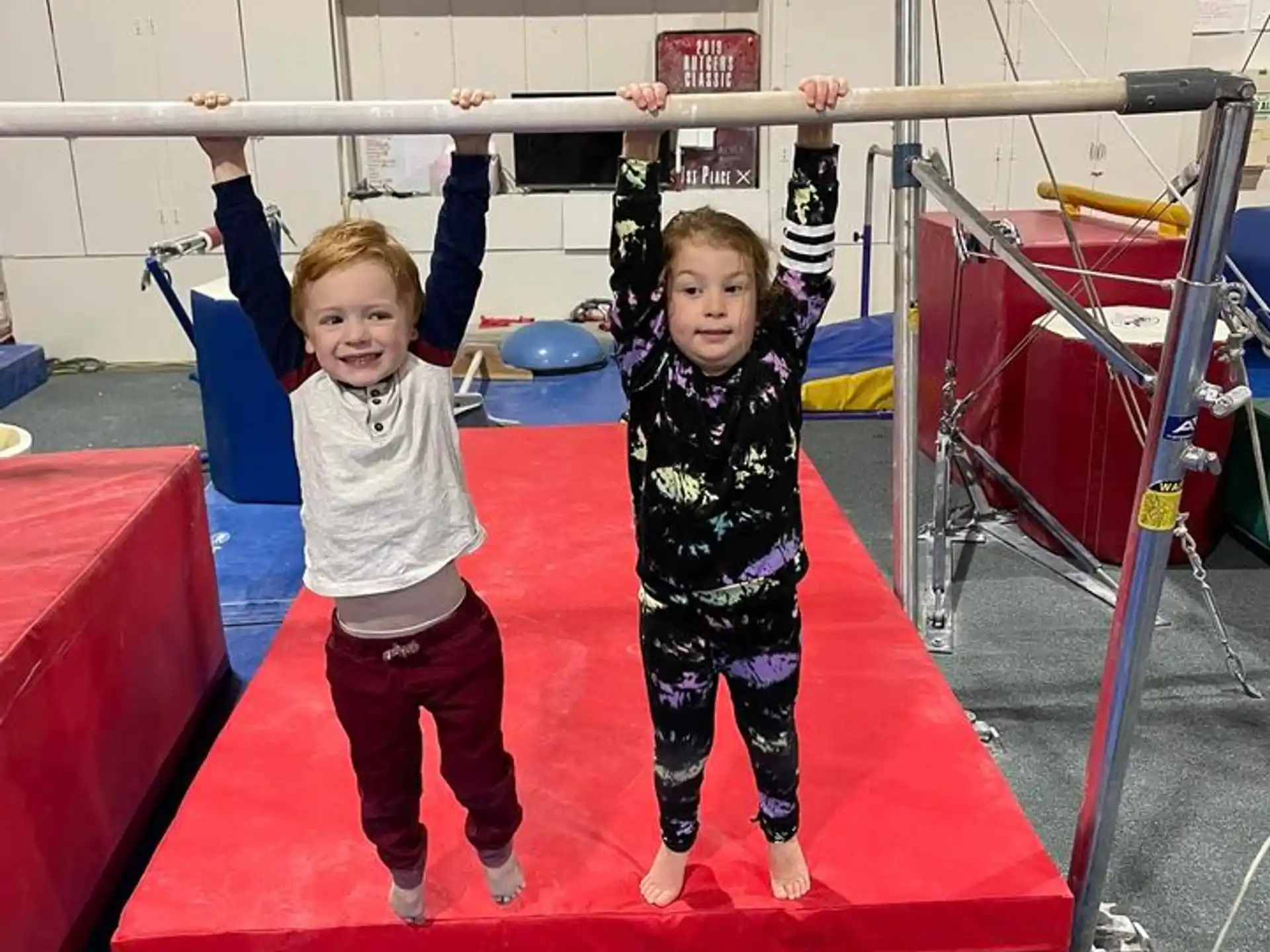 a couple of children on a bar