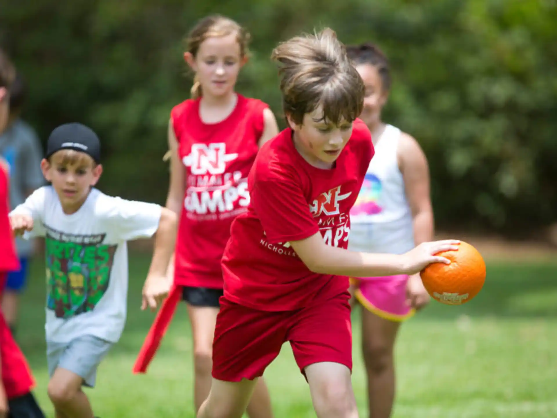 a group of kids playing with a ball