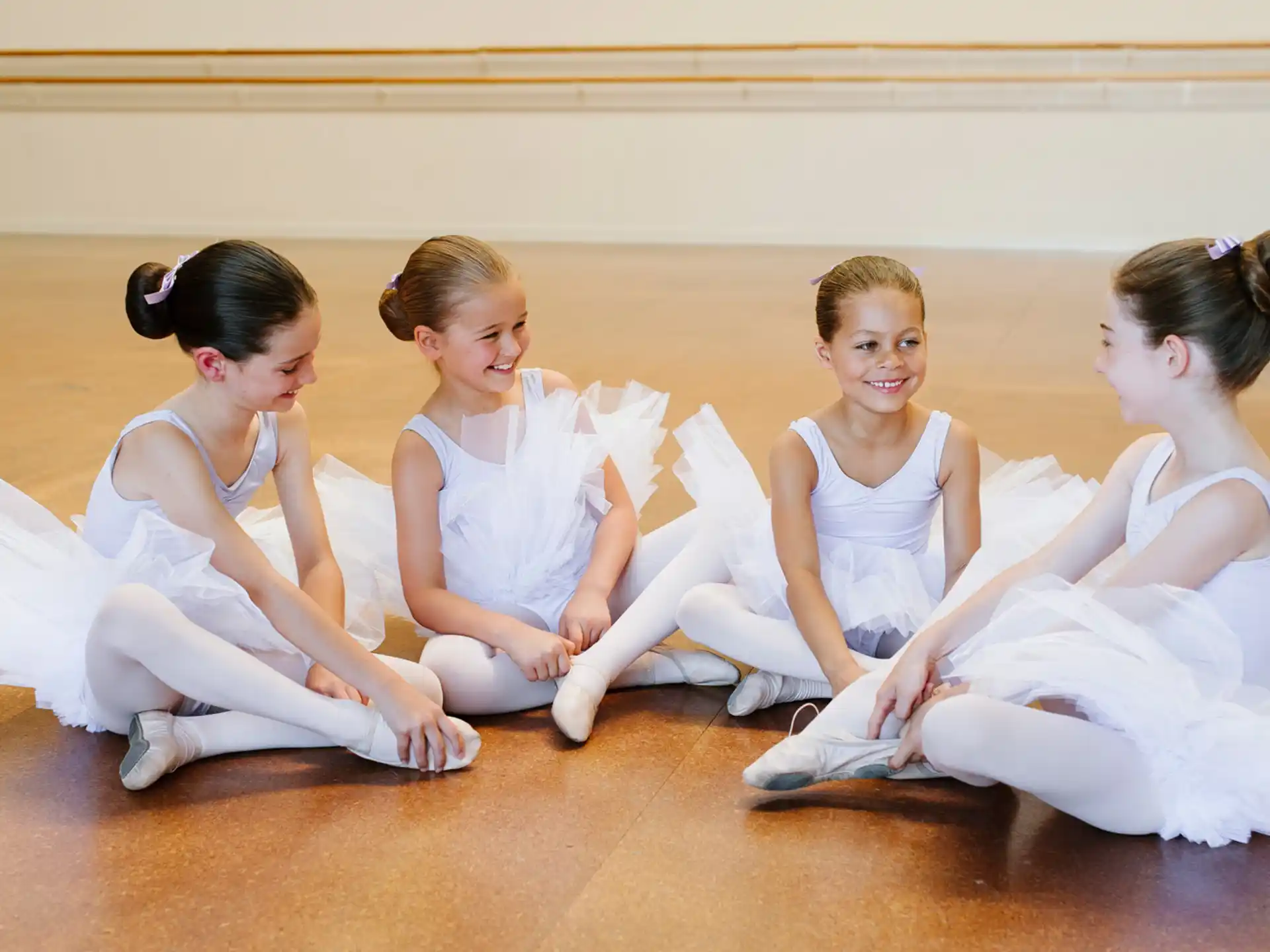 a group of women in white dresses