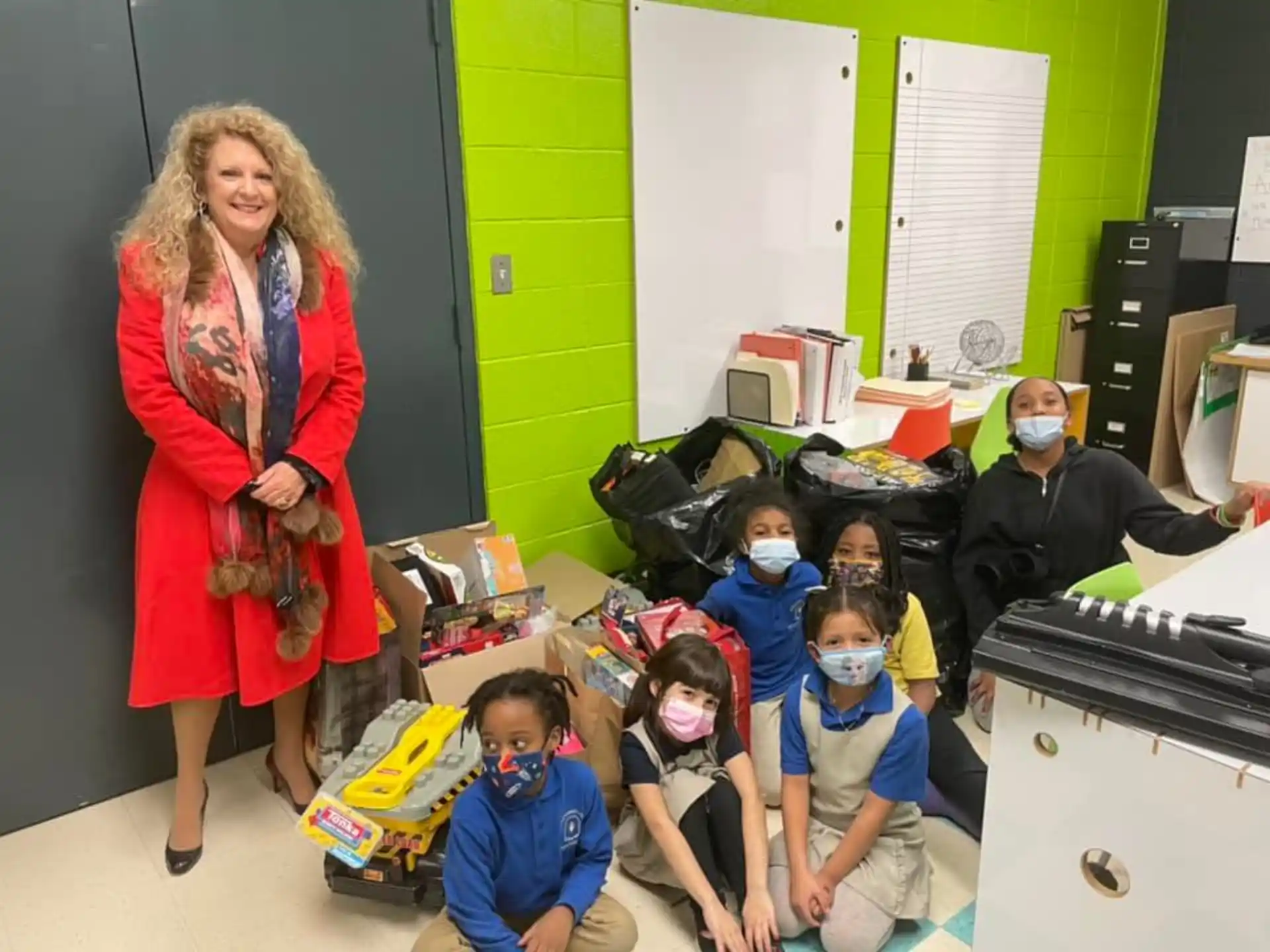 a woman and a group of children wearing masks