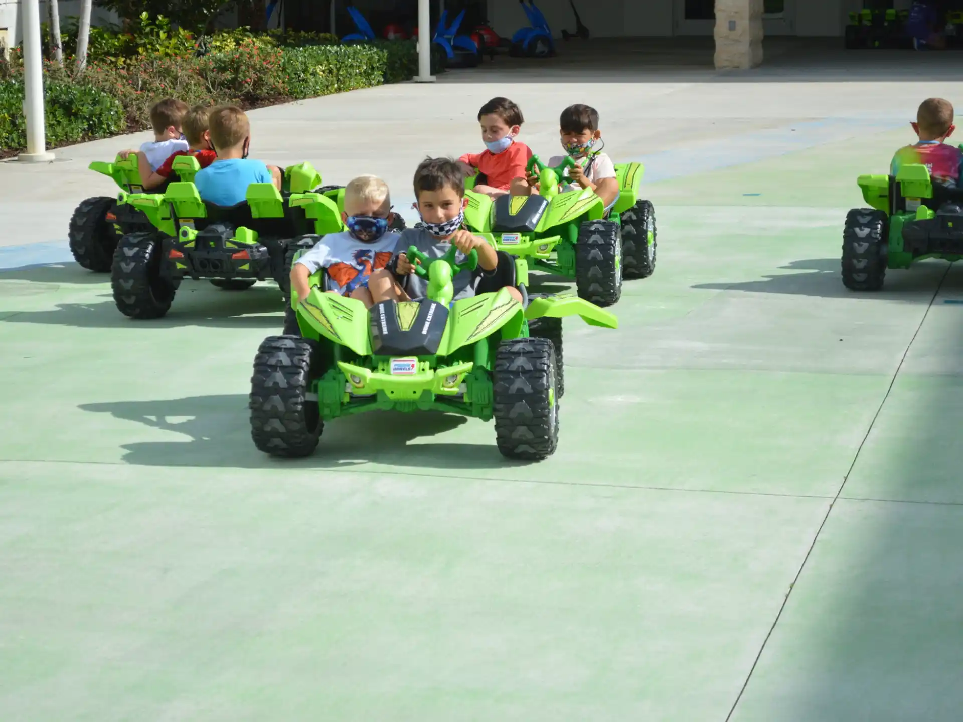 kids riding toy cars