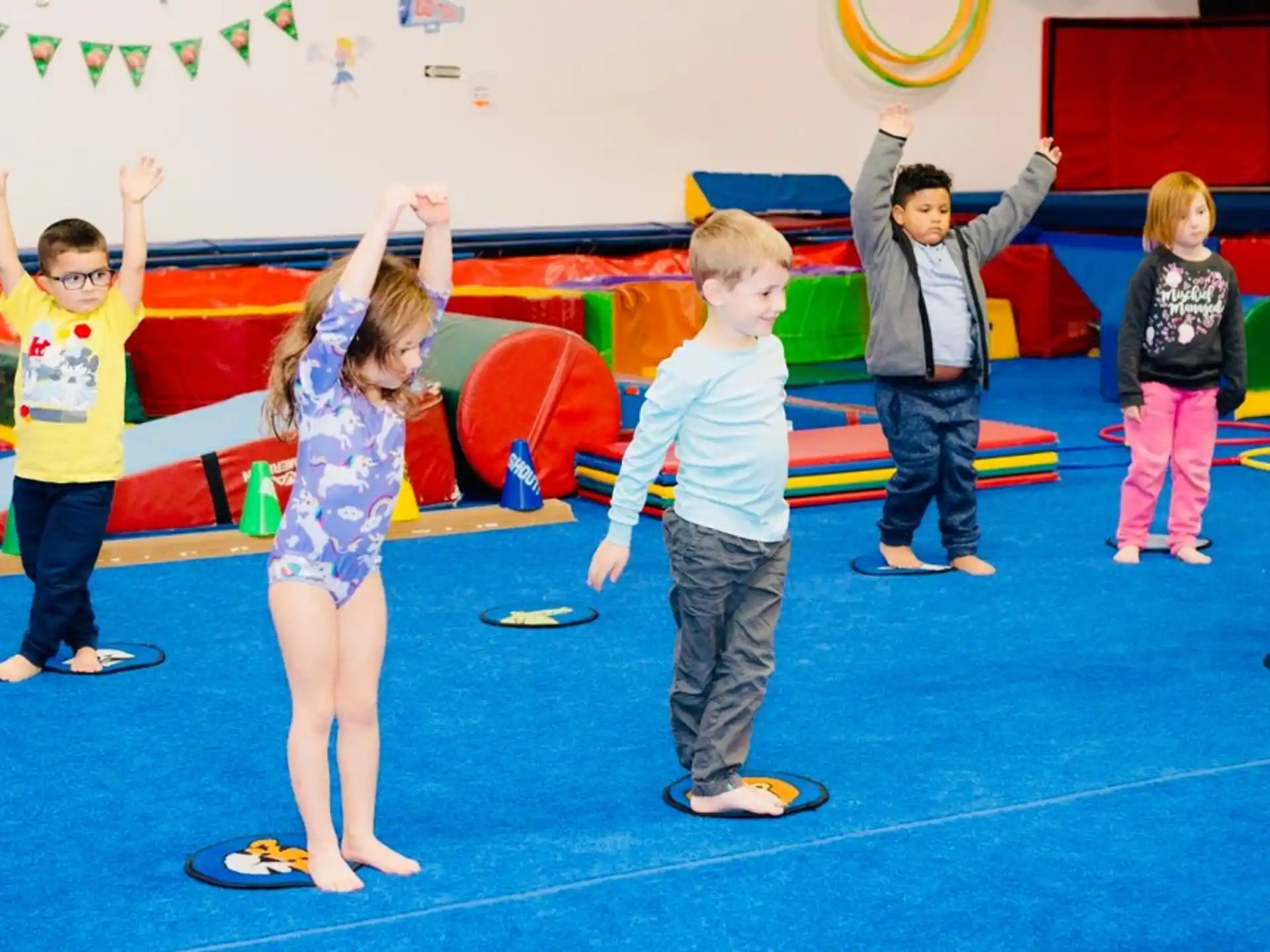 a group of children raising their hands