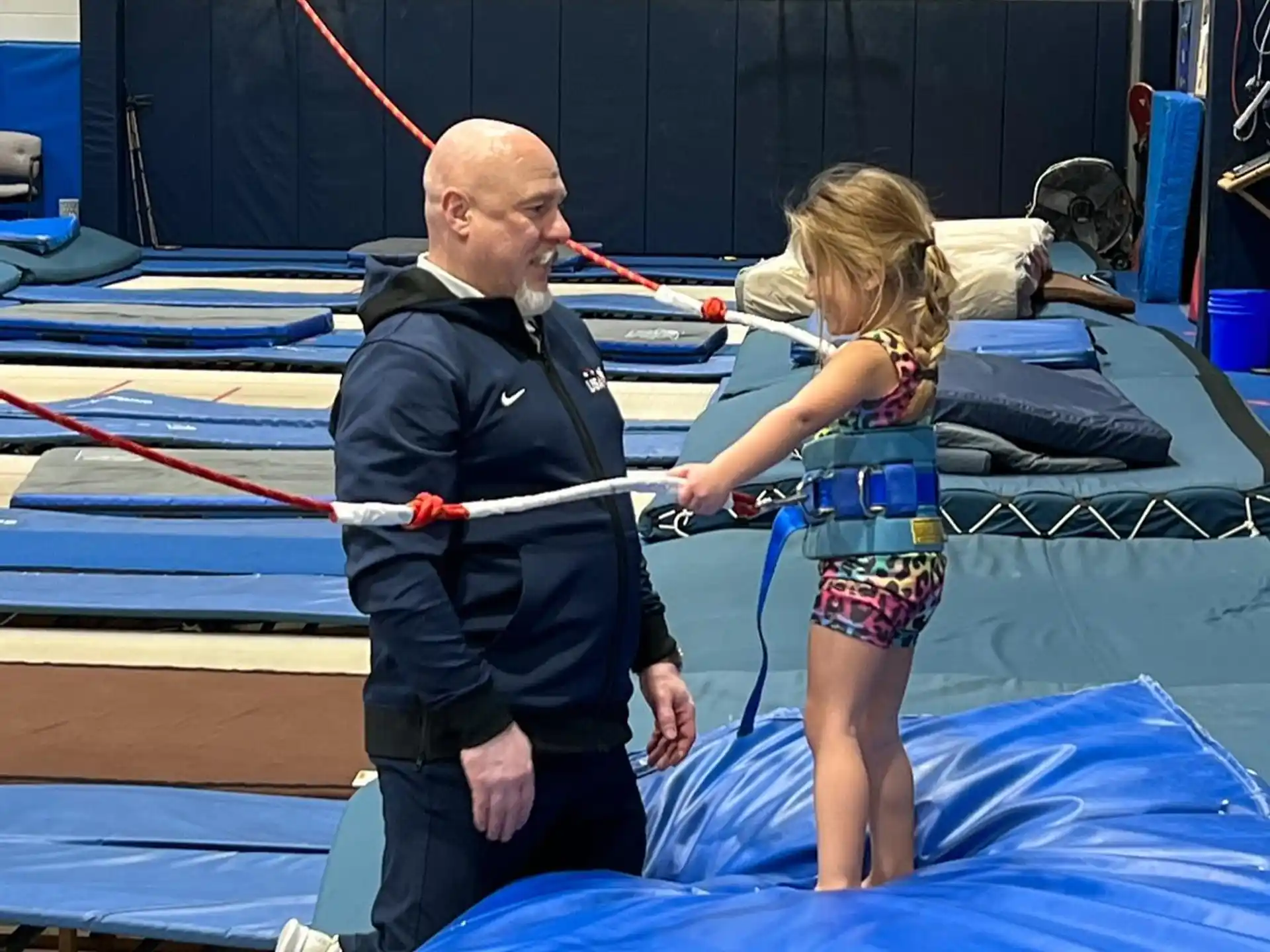 a person and a girl on a trampoline