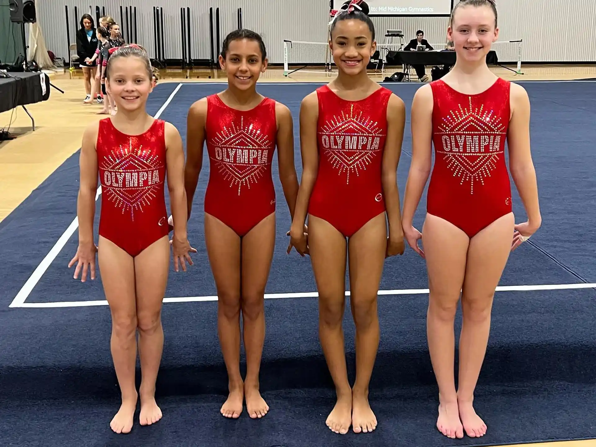 a group of women in leotards posing for a photo
