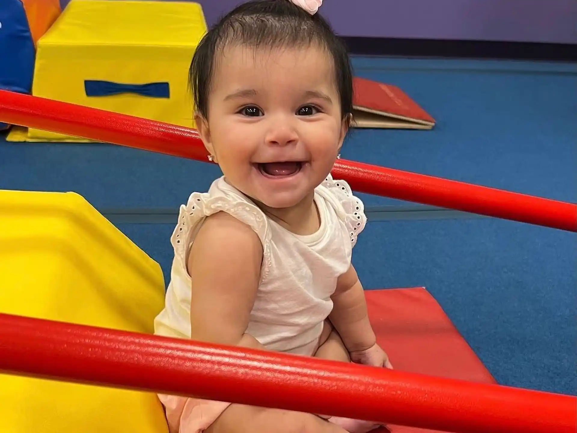 a baby sitting in a toy pool