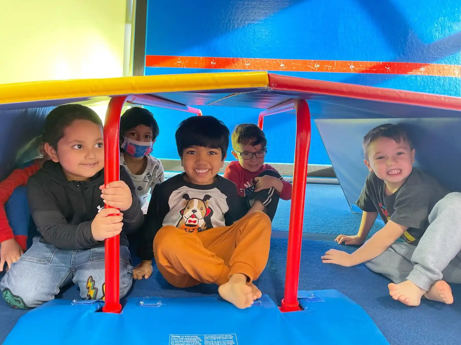 a group of kids sitting on a slide
