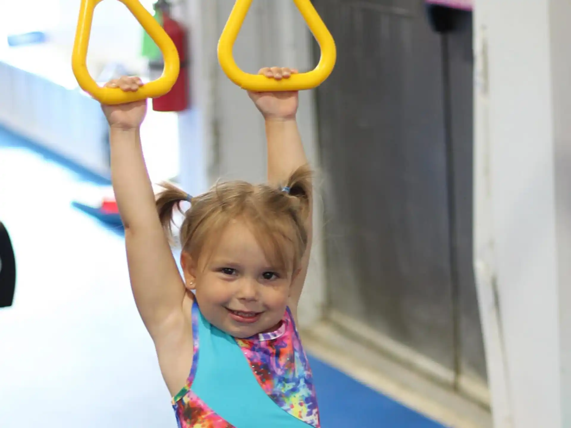 a girl holding a yellow hoop