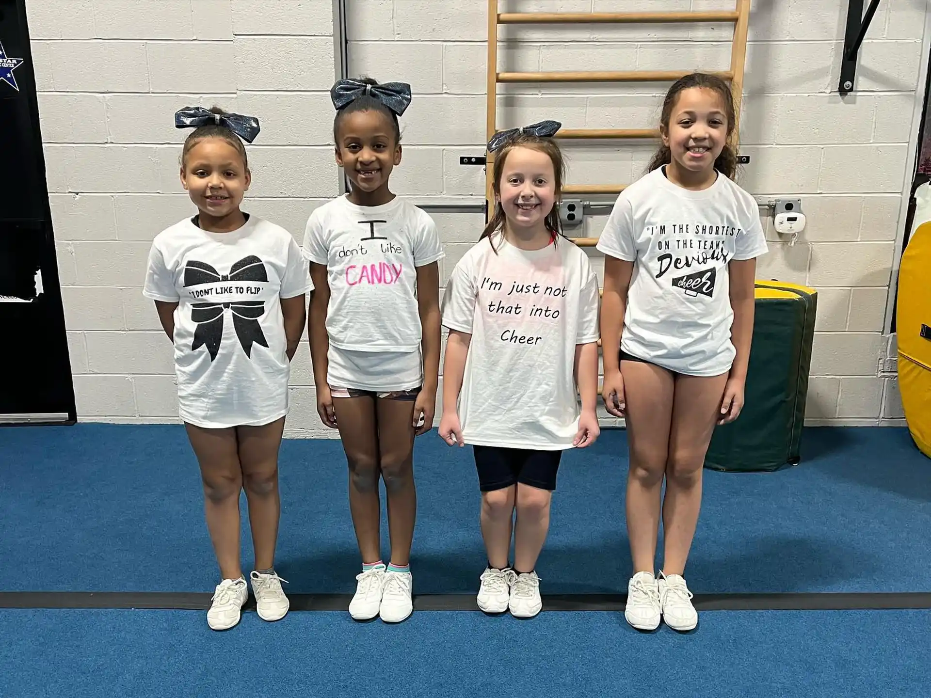 a group of girls wearing white shirts