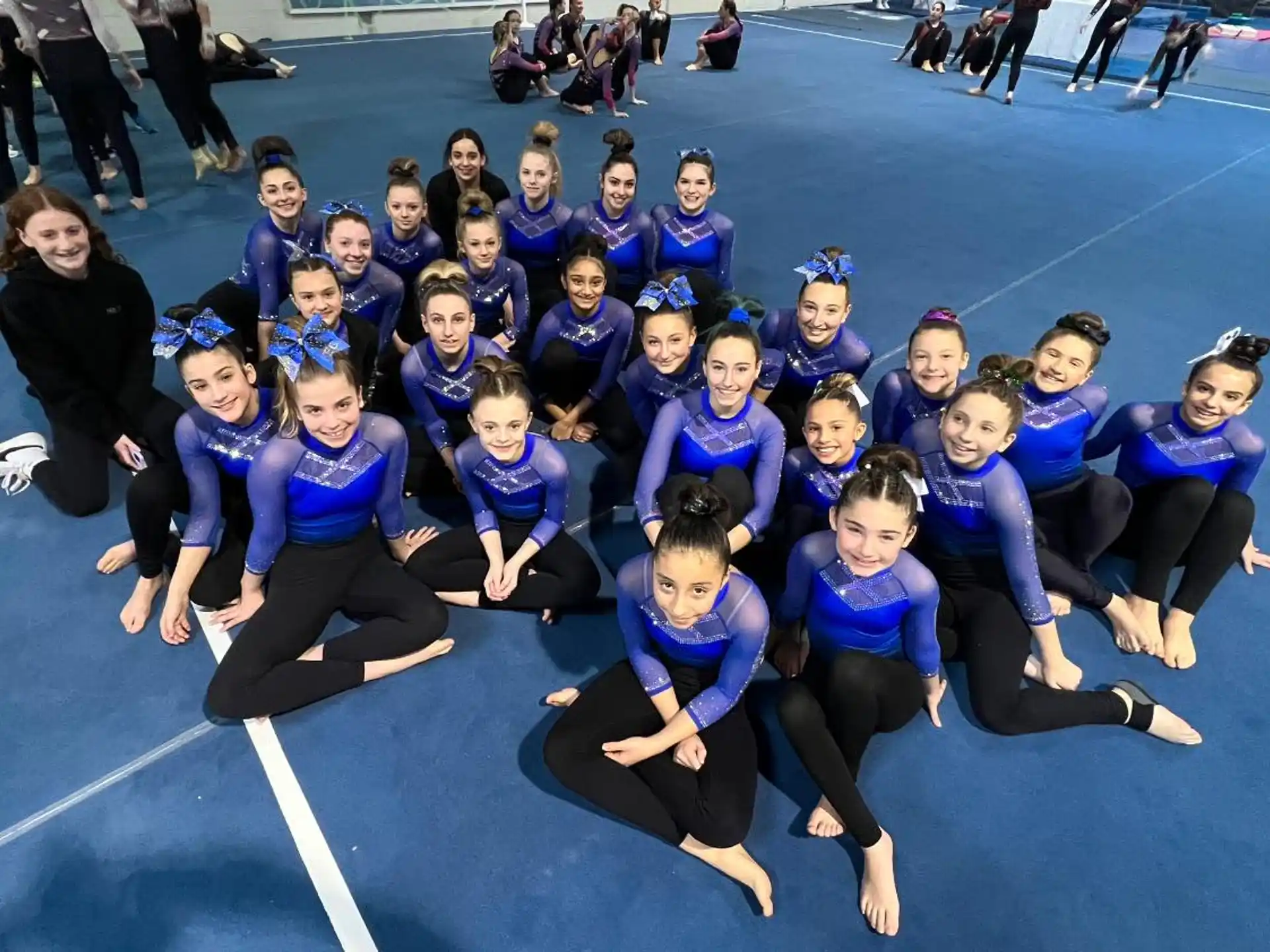 a group of girls in blue uniforms