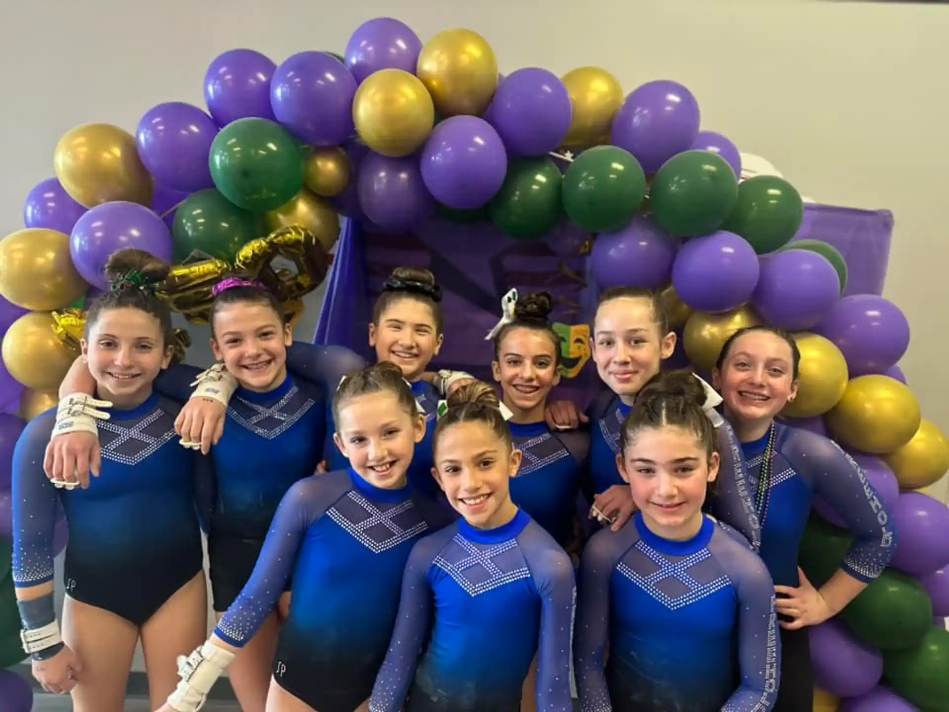 a group of girls posing for a photo with balloons
