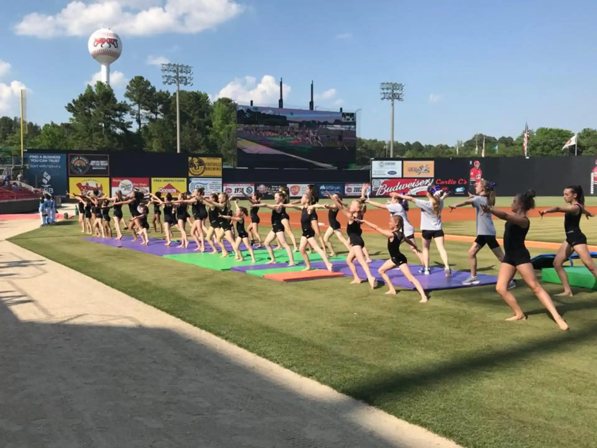 a group of people running on a track with a crowd watching