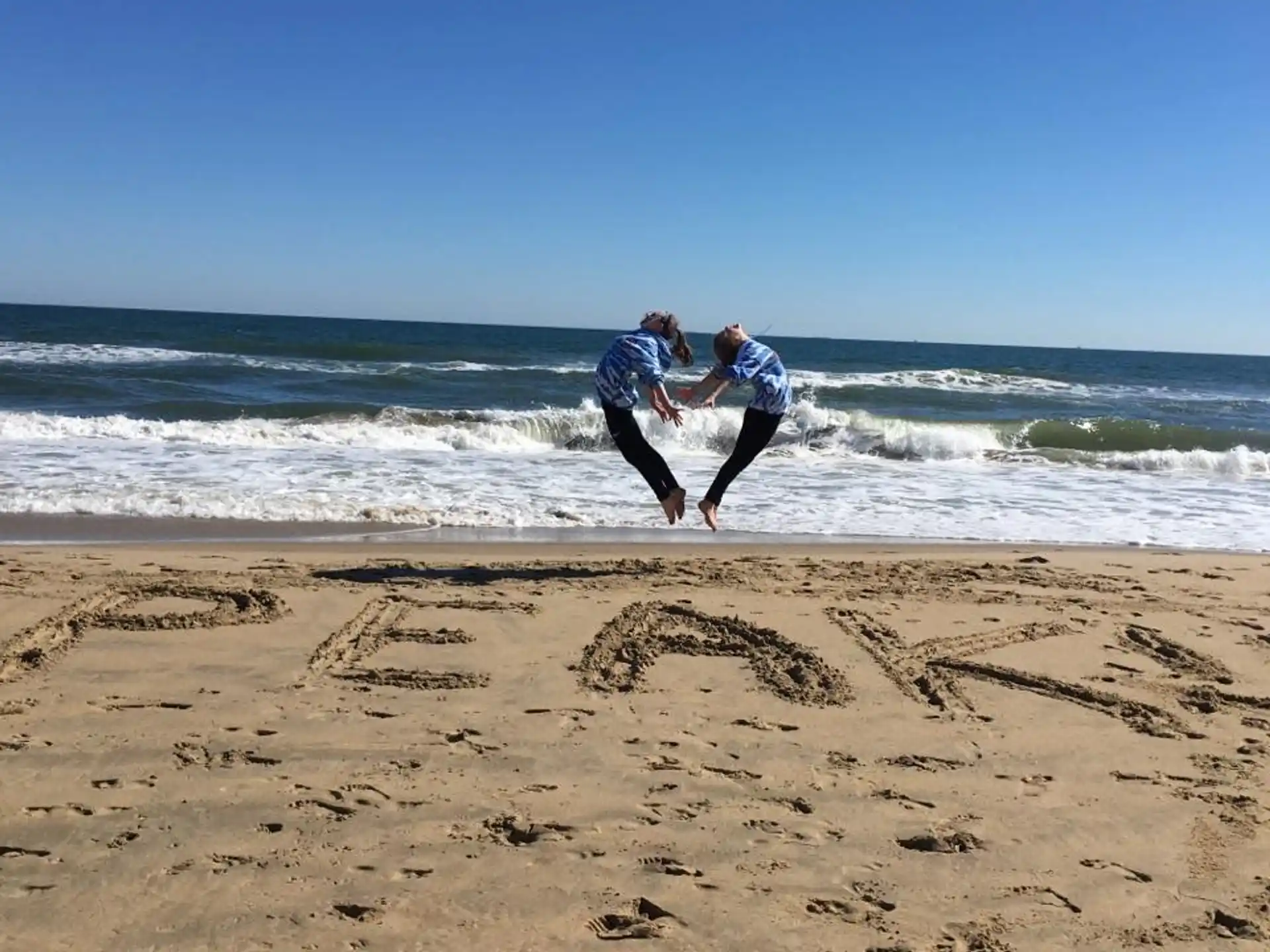 two people running on a beach