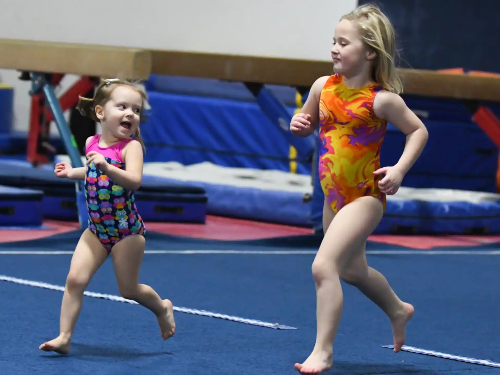 two girls running on a track