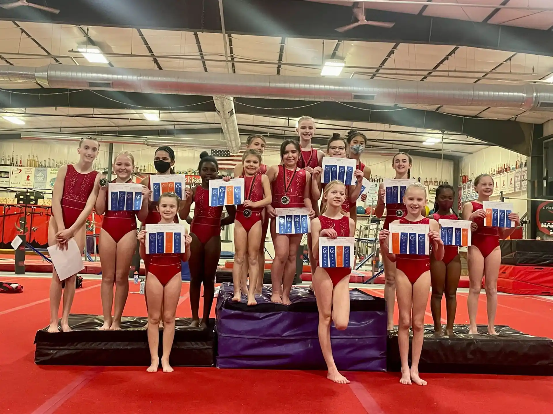 a group of women in red and white leotards posing for a photo