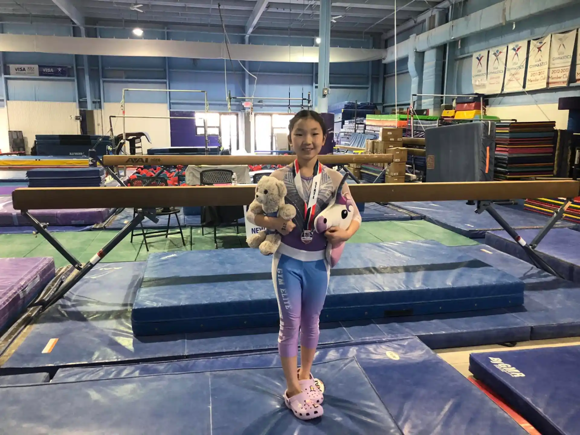 a girl holding a stuffed animal