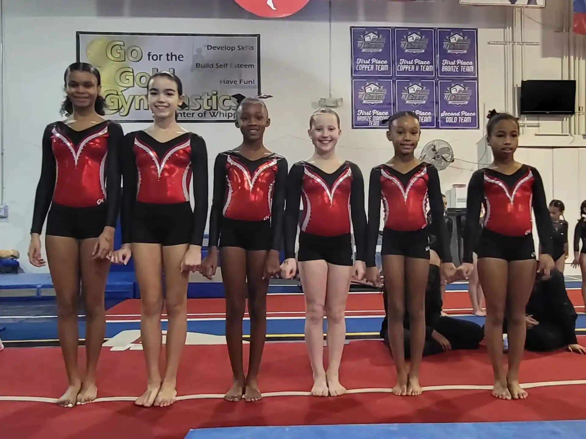 a group of women in athletic wear