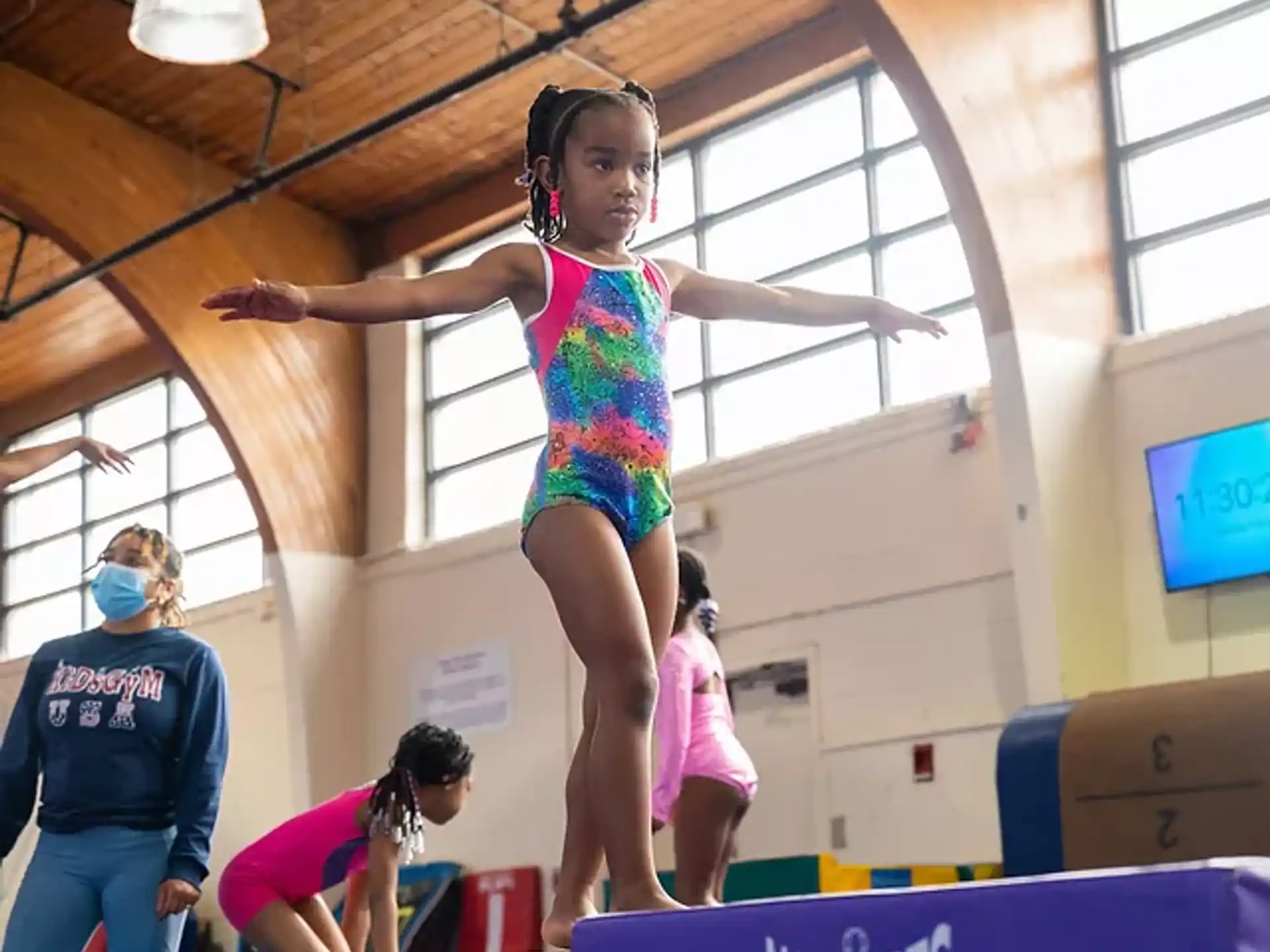 a person in a leotard doing a handstand