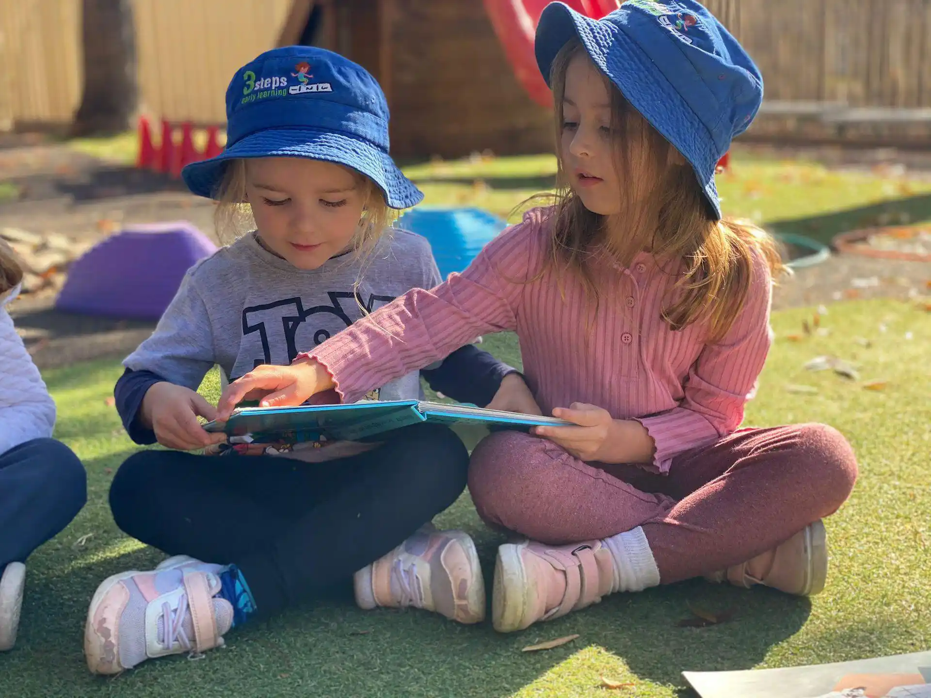 a couple of children sitting on the ground