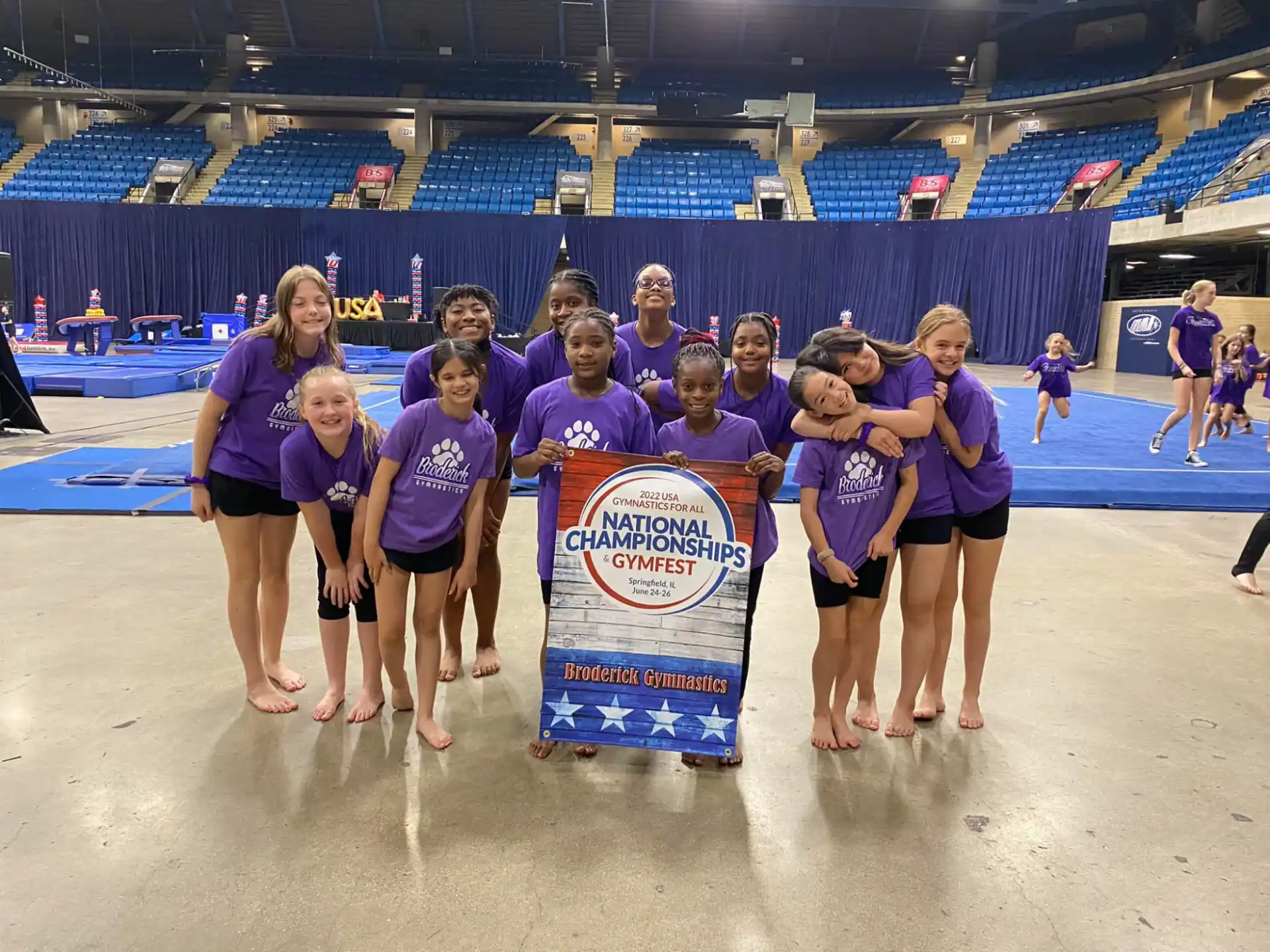 a group of people wearing purple shirts holding a sign